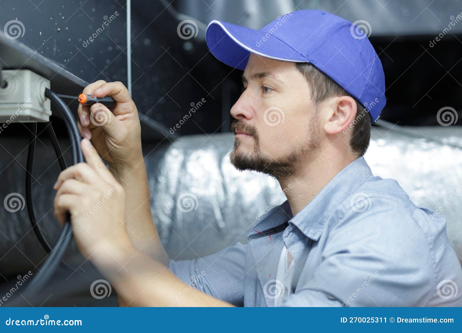 Electrician Measuring Voltage Cable on Ceiling Indoors Stock Image