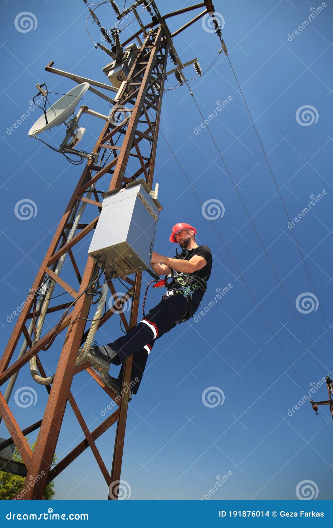 Electrician in Red Helmet Working on SCADA Antenna System Stock Photo