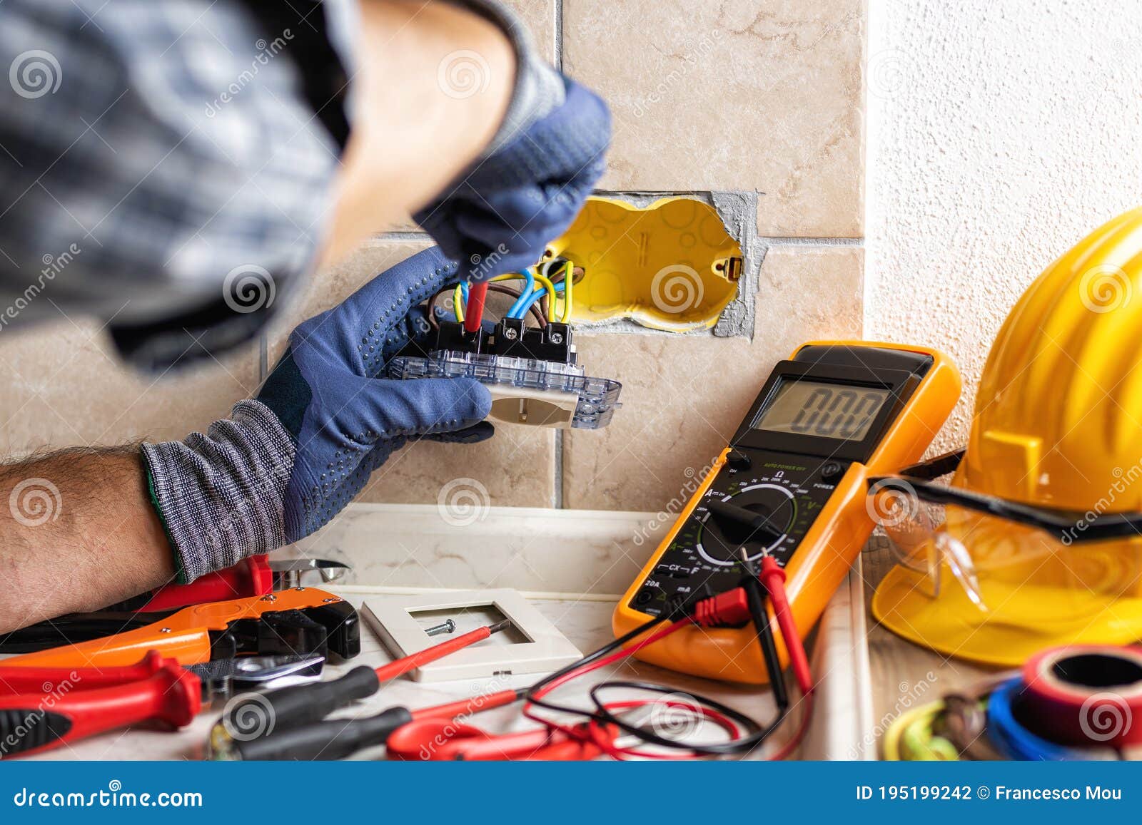 Electrician at Work with Safety Equipment on a Residential Electrical
