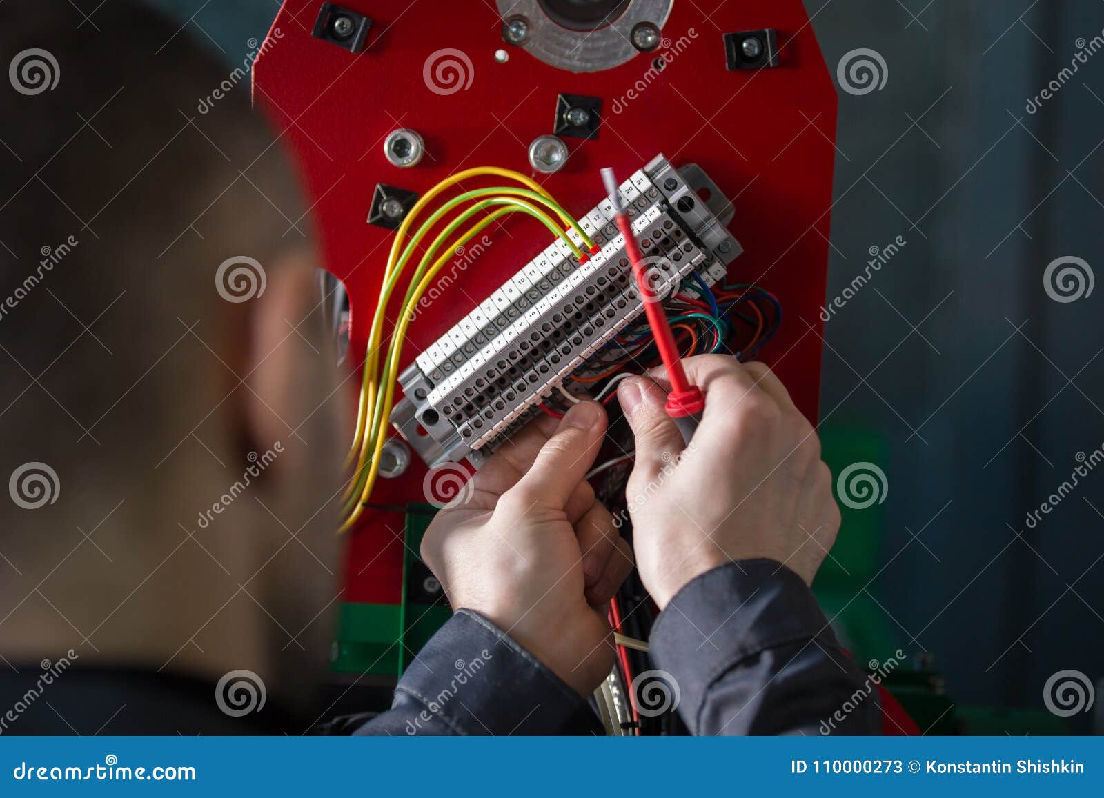 Electrician works with hands of electric - wires and equipment