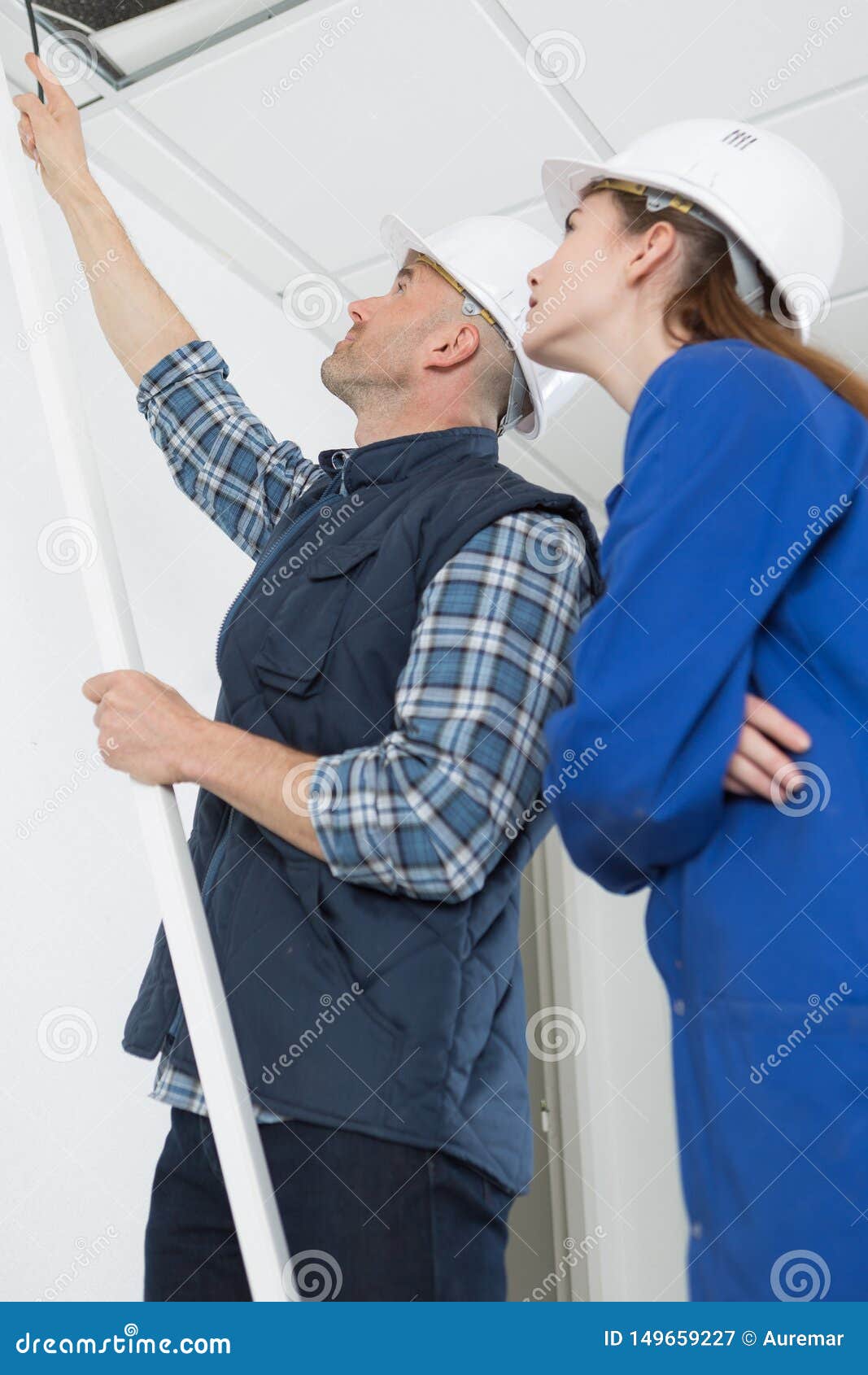 Electricians Installing Ceiling Lights in Domestic Home Stock Image