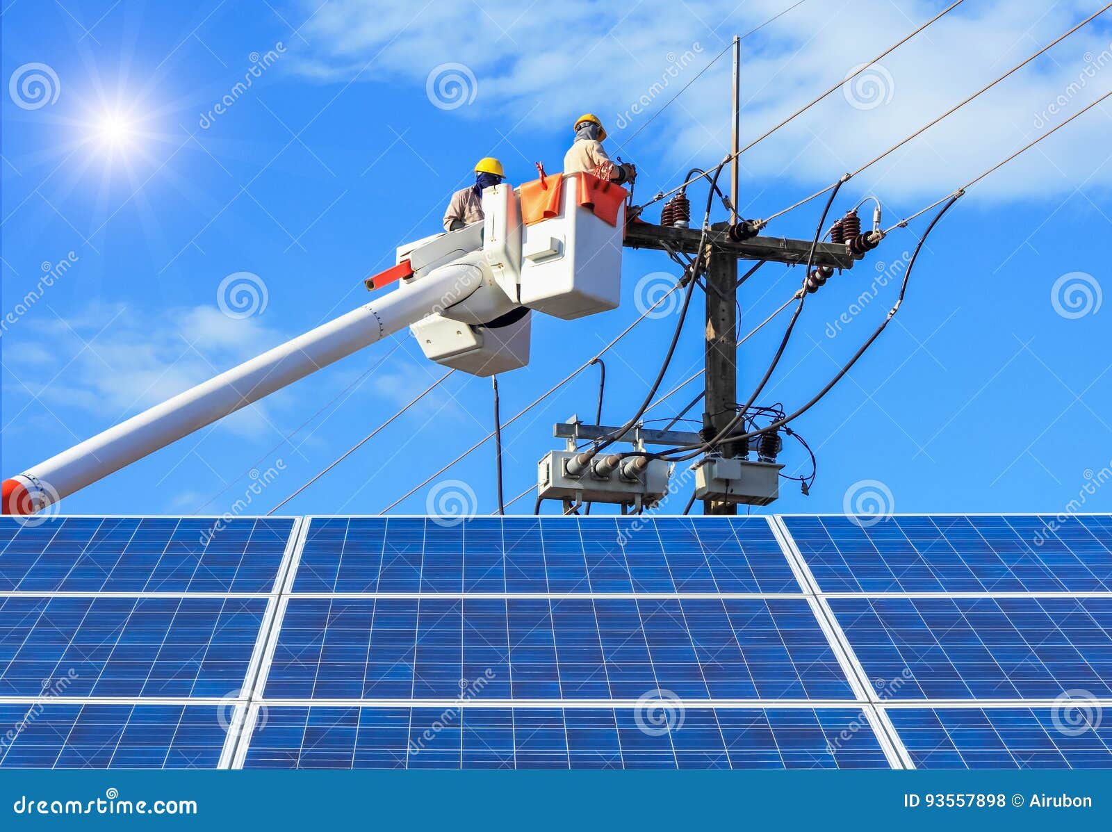 electricians repairing wire of the power line on bucket hydraulic lifting platform with photovoltaics in solar power station