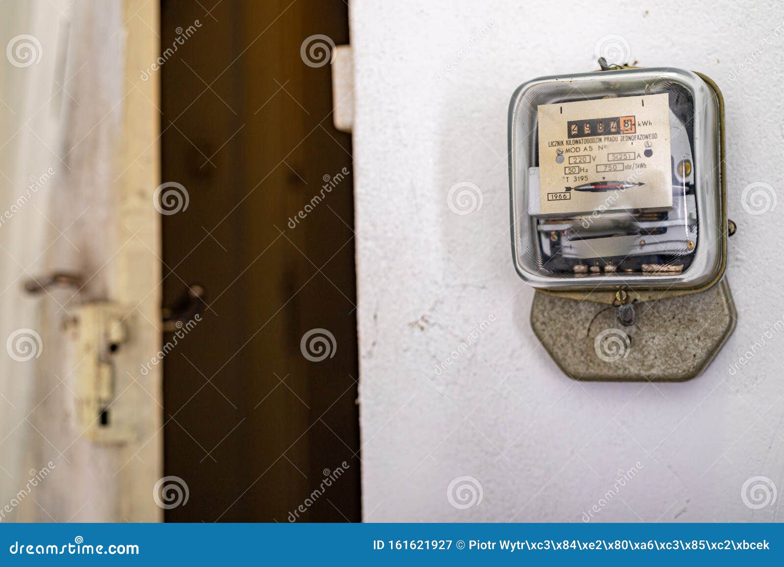 Electricity Meter On A White Wall. A Device For Measuring The