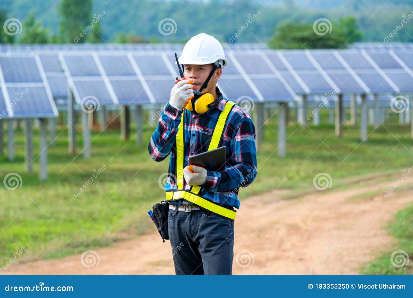 Engineer Checking Solar Panel in Routine Operation at Solar Power Plant