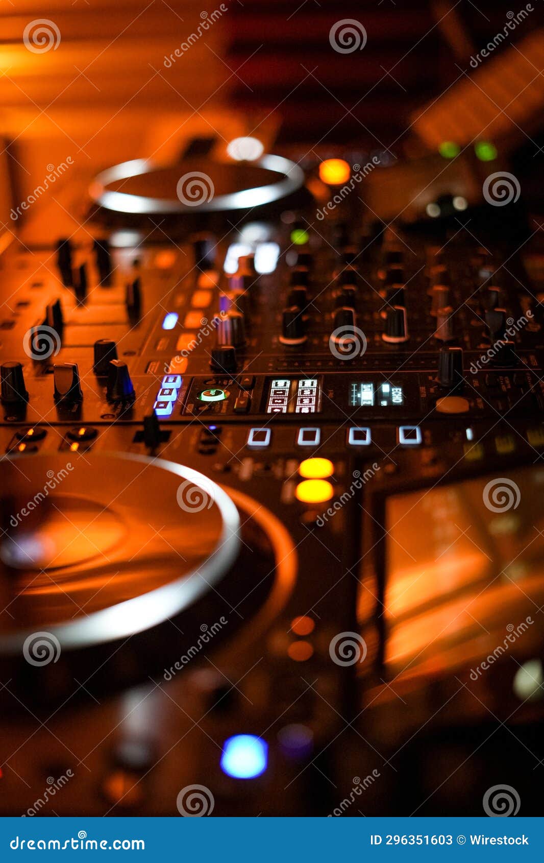 Electronic DJ Turntable and Controller Illuminated in the Darkness