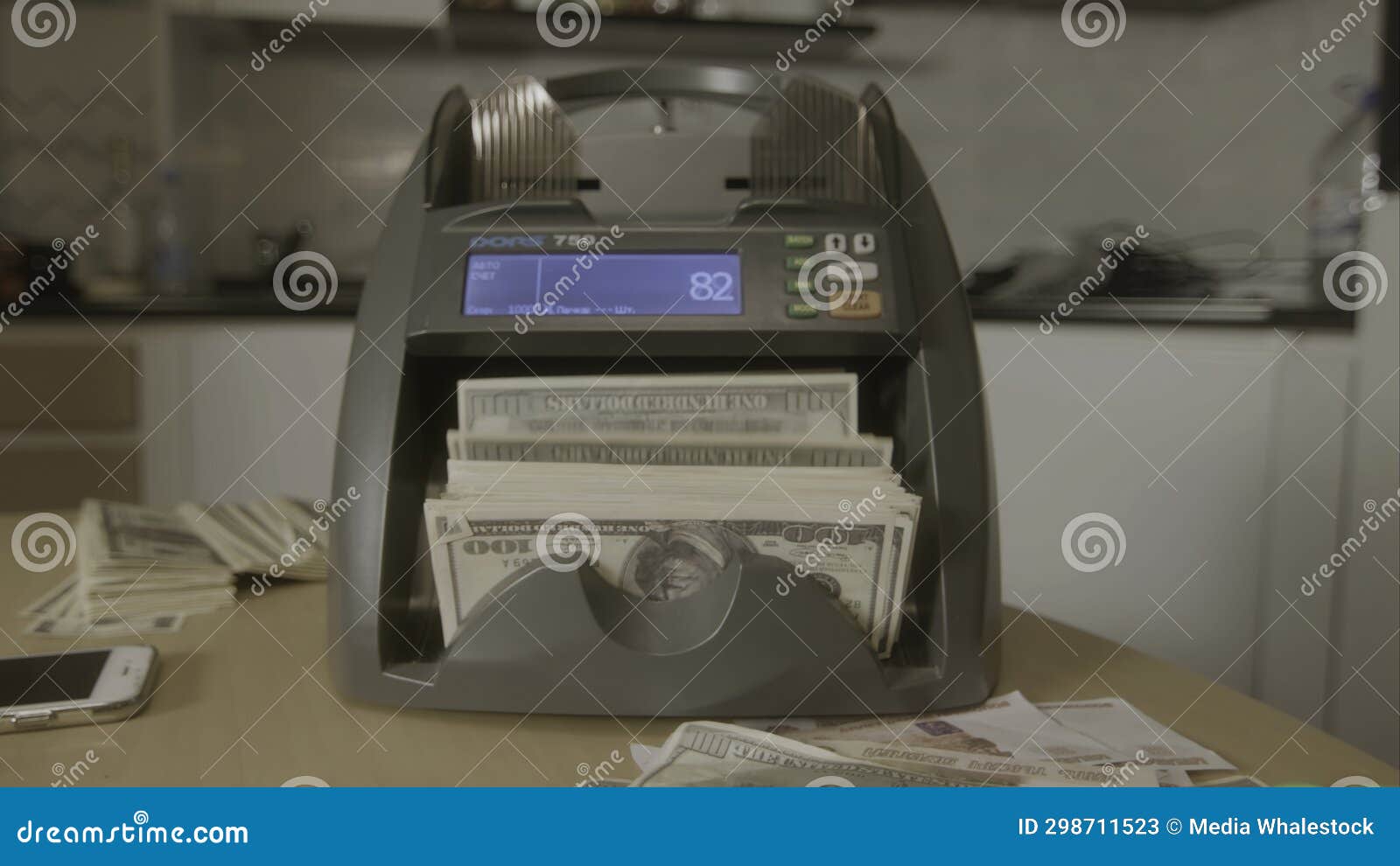 Electronic Money Counter Machine is Counting the Dollar Banknotes