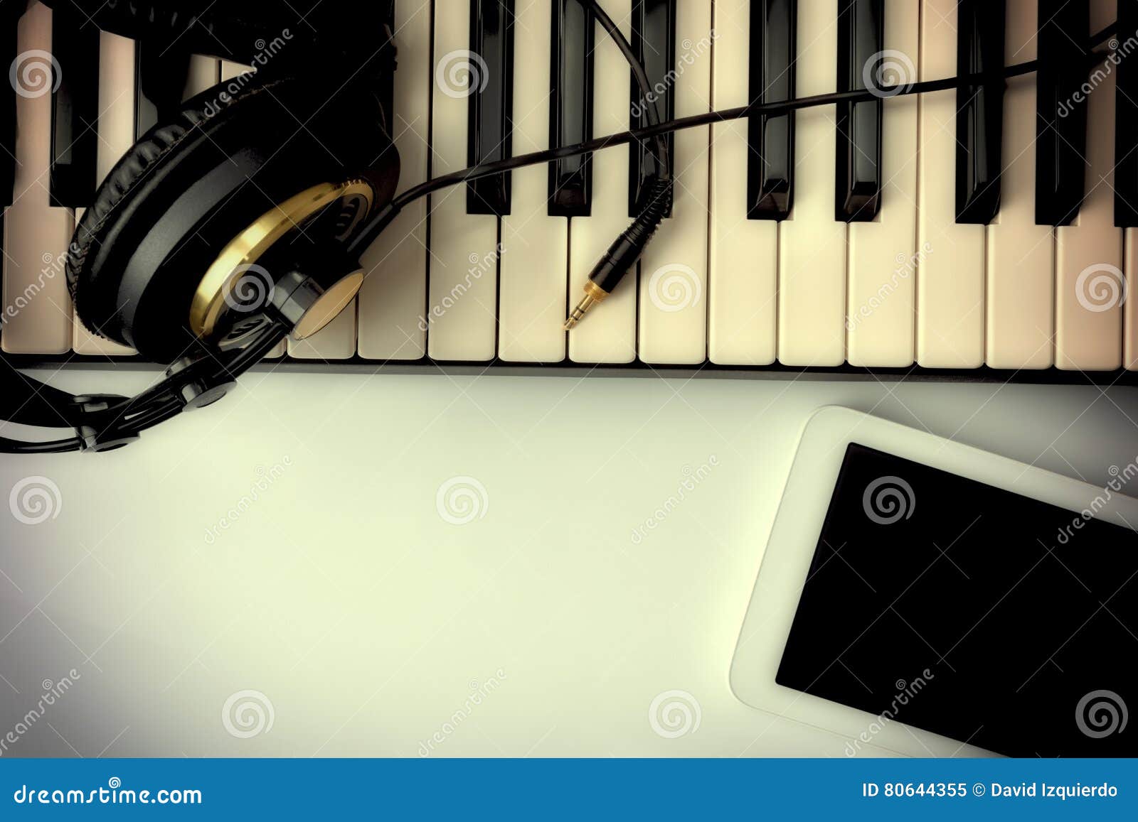 Electronic Piano with Headphones and Tablet for Musical Composition