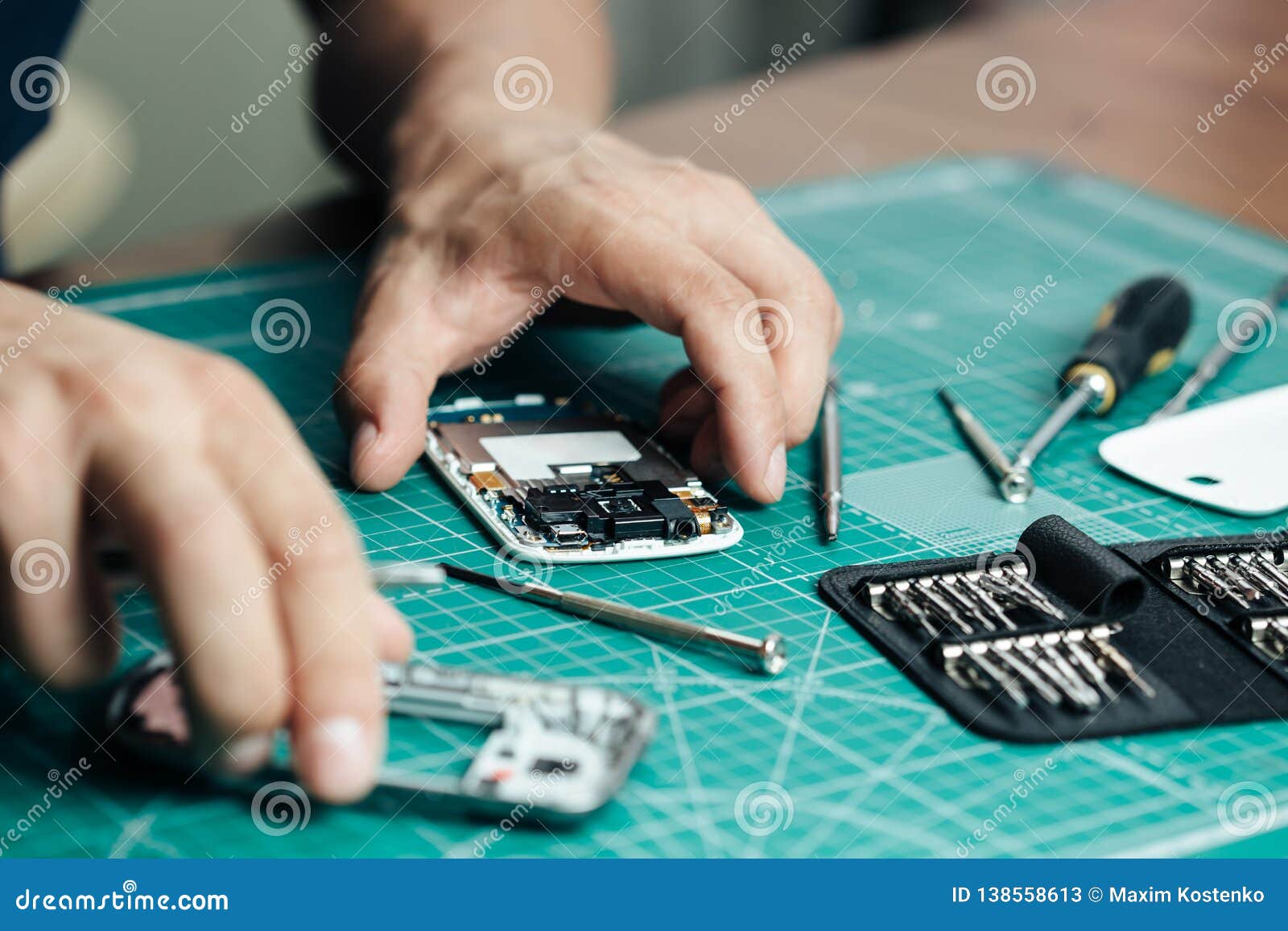 Electronics Repair Service. Technician Disassembling Smartphone for