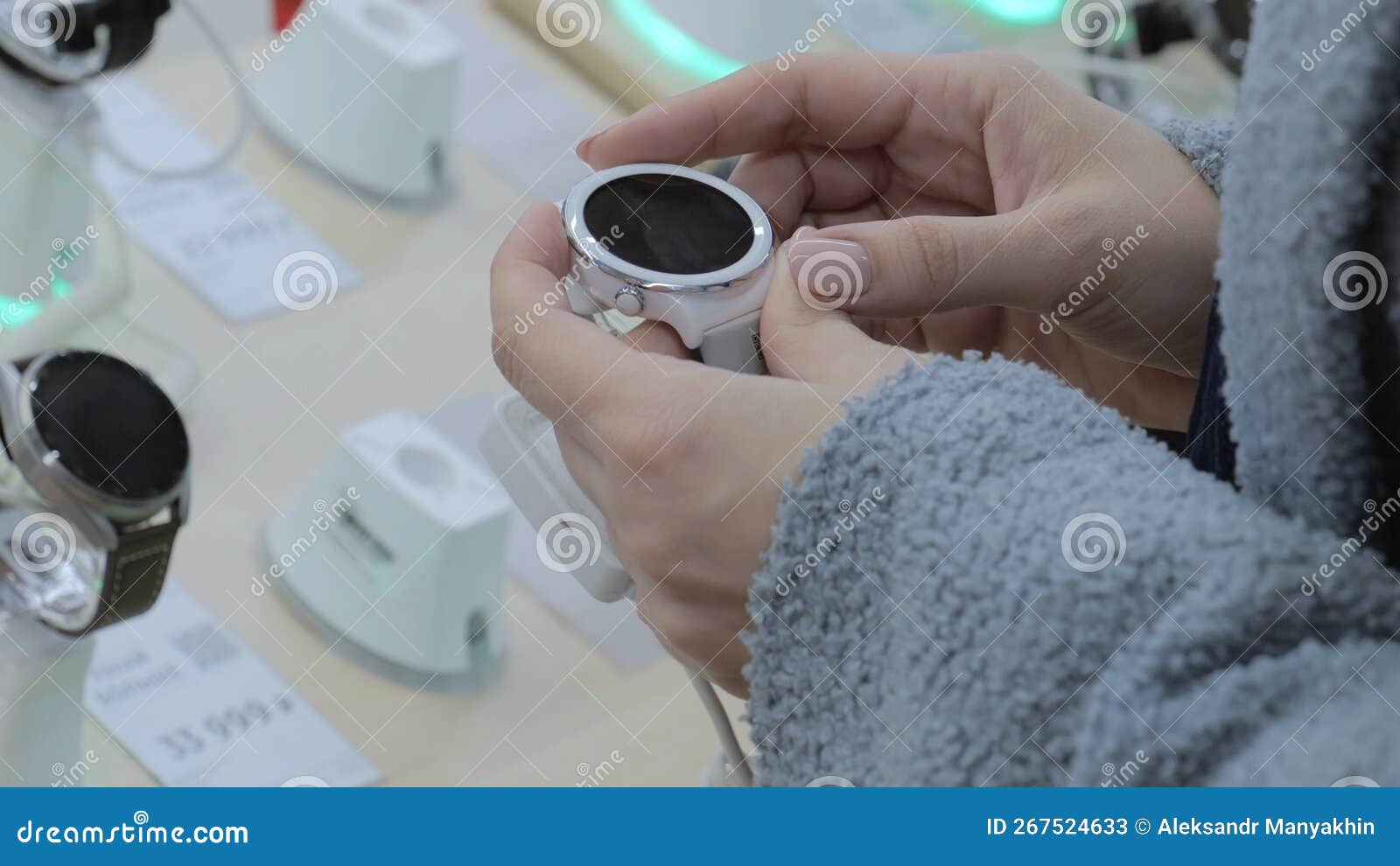 Electronics Store, Girl Looks at Smart Watch, Modern Technology Stock