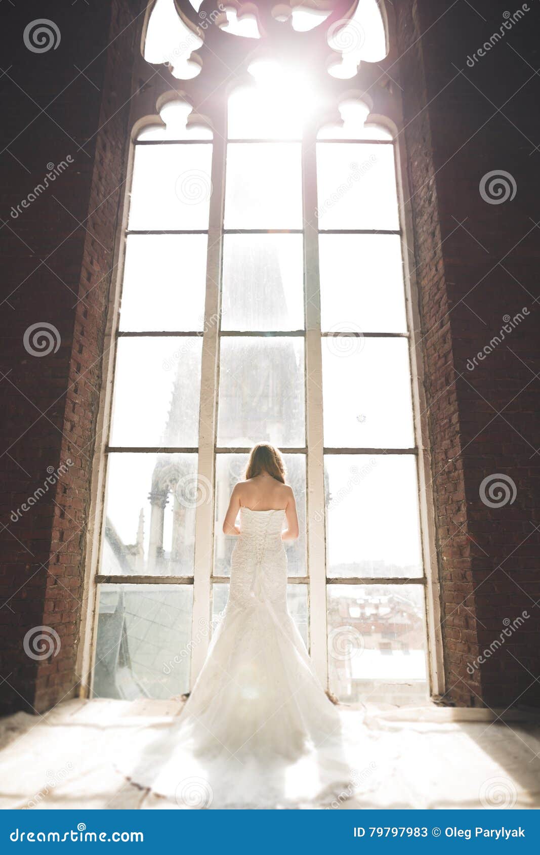 Elegant Beautiful Wedding Bride Posing Near Great Window Arch Stock