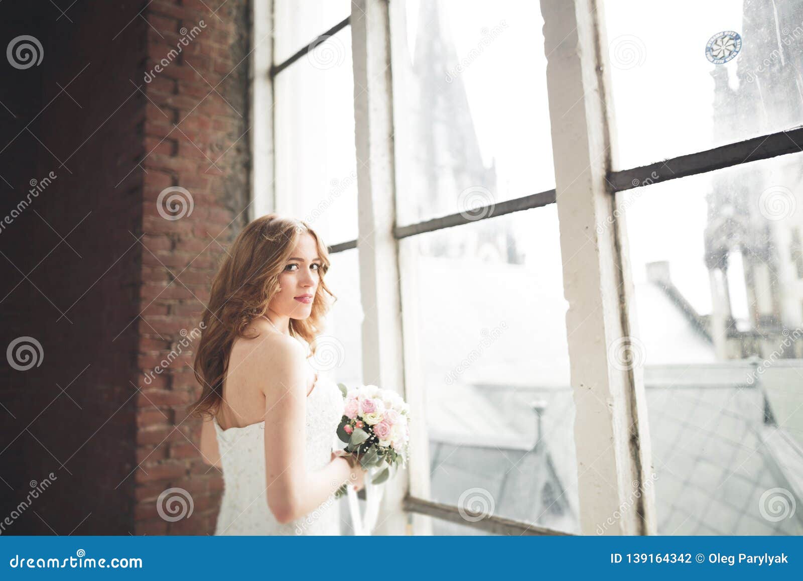 Elegant Beautiful Wedding Bride Posing Near Great Window Arch Stock