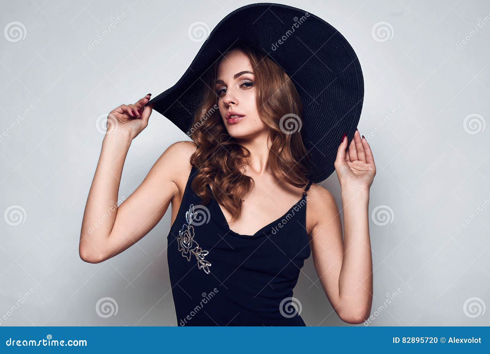 Elegant Beautiful Woman in a Black Dress and Hat Stock Photo - Image of ...