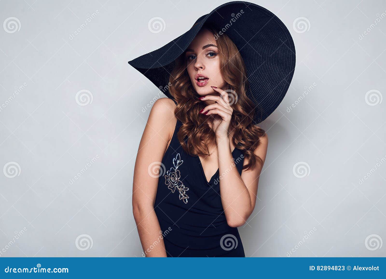 Elegant Beautiful Woman in a Black Dress and Hat Stock Image - Image of ...