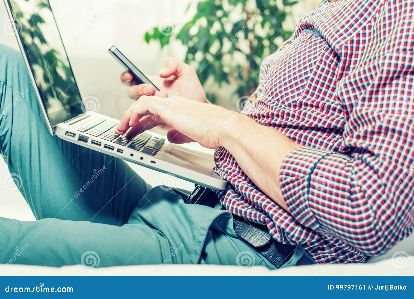 Elegant Business Multitasking Multimedia Man Using Devices at Home