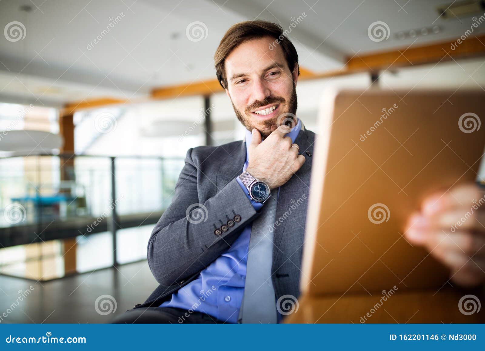 Elegant Business Multitasking Multimedia Man Using Devices Stock Photo