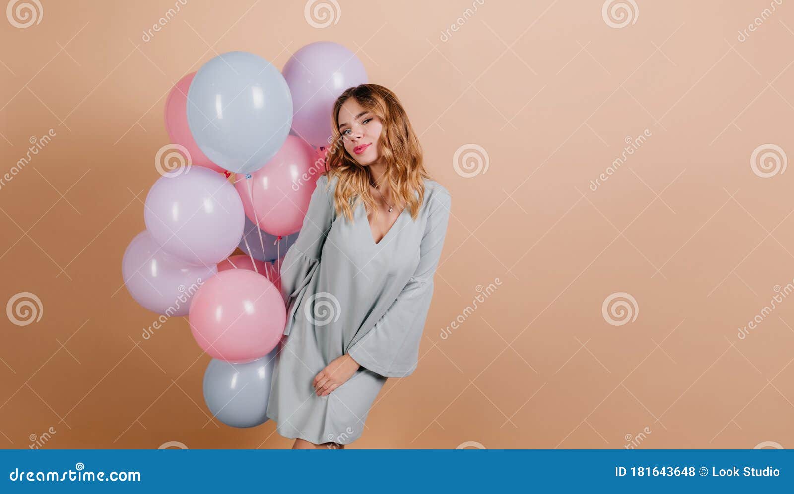 Elegant Fair-haired Girl with Bunch of Balloons Posing with Smile ...