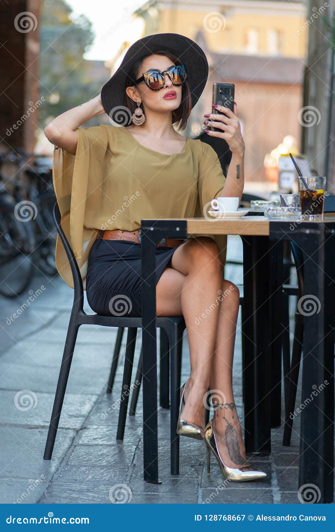 Elegant Italian Woman With Hat And Glasses Checks Her Makeup On Her