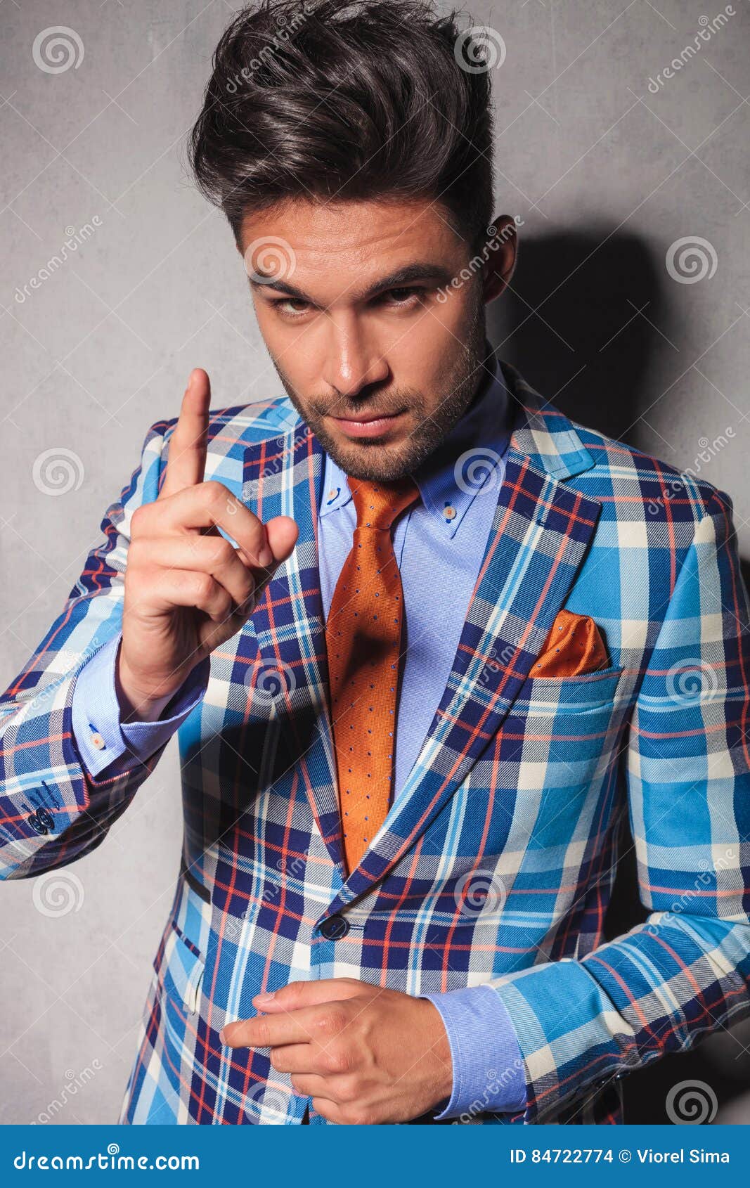 elegant man in checkered suit gesturing for you to behave