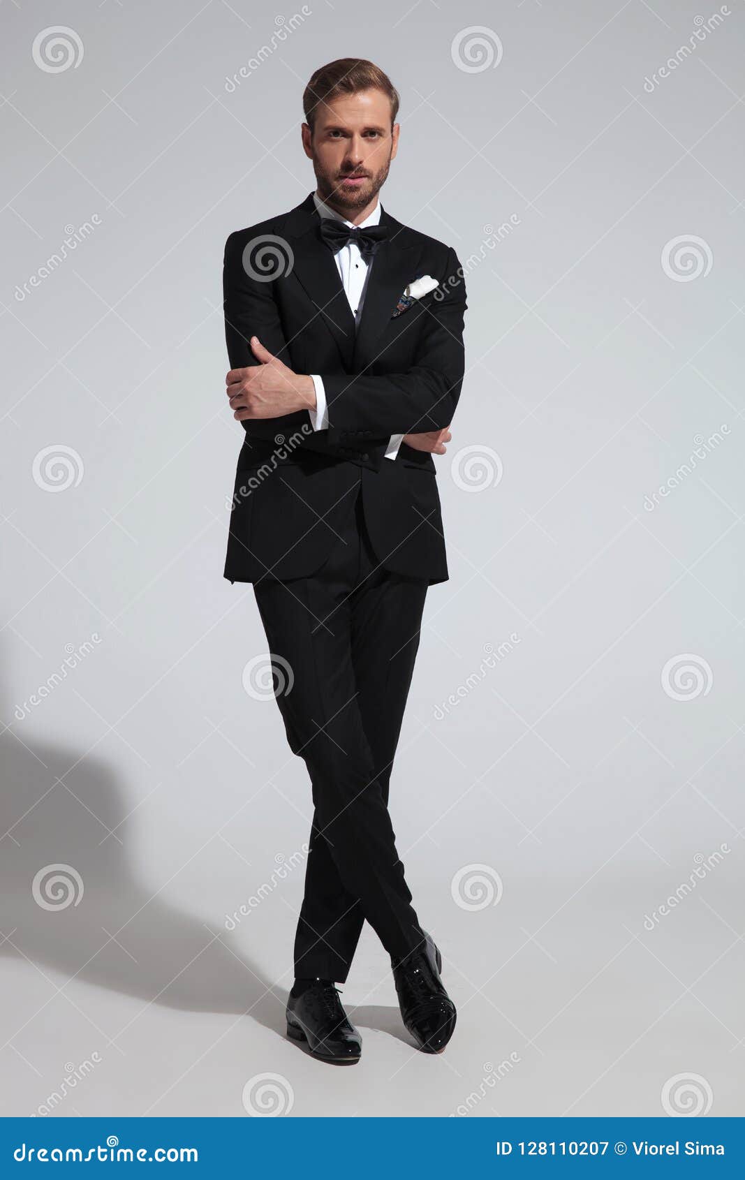 Elegant Man in Tuxedo Standing with Hands and Leg Crossed Stock Image ...