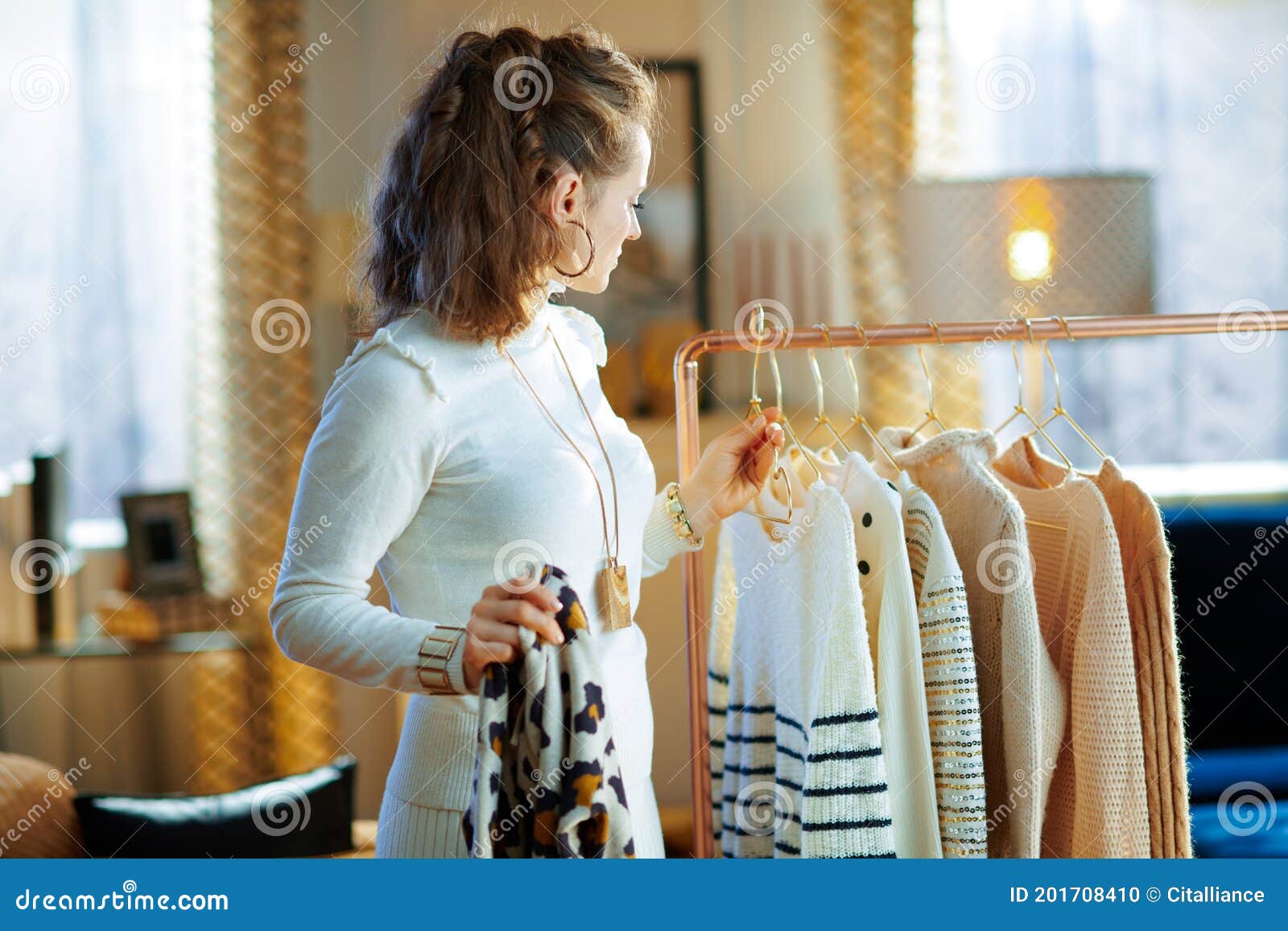 Elegant Housewife Choosing Sweaters Hanging on Clothes Rack Stock Photo ...