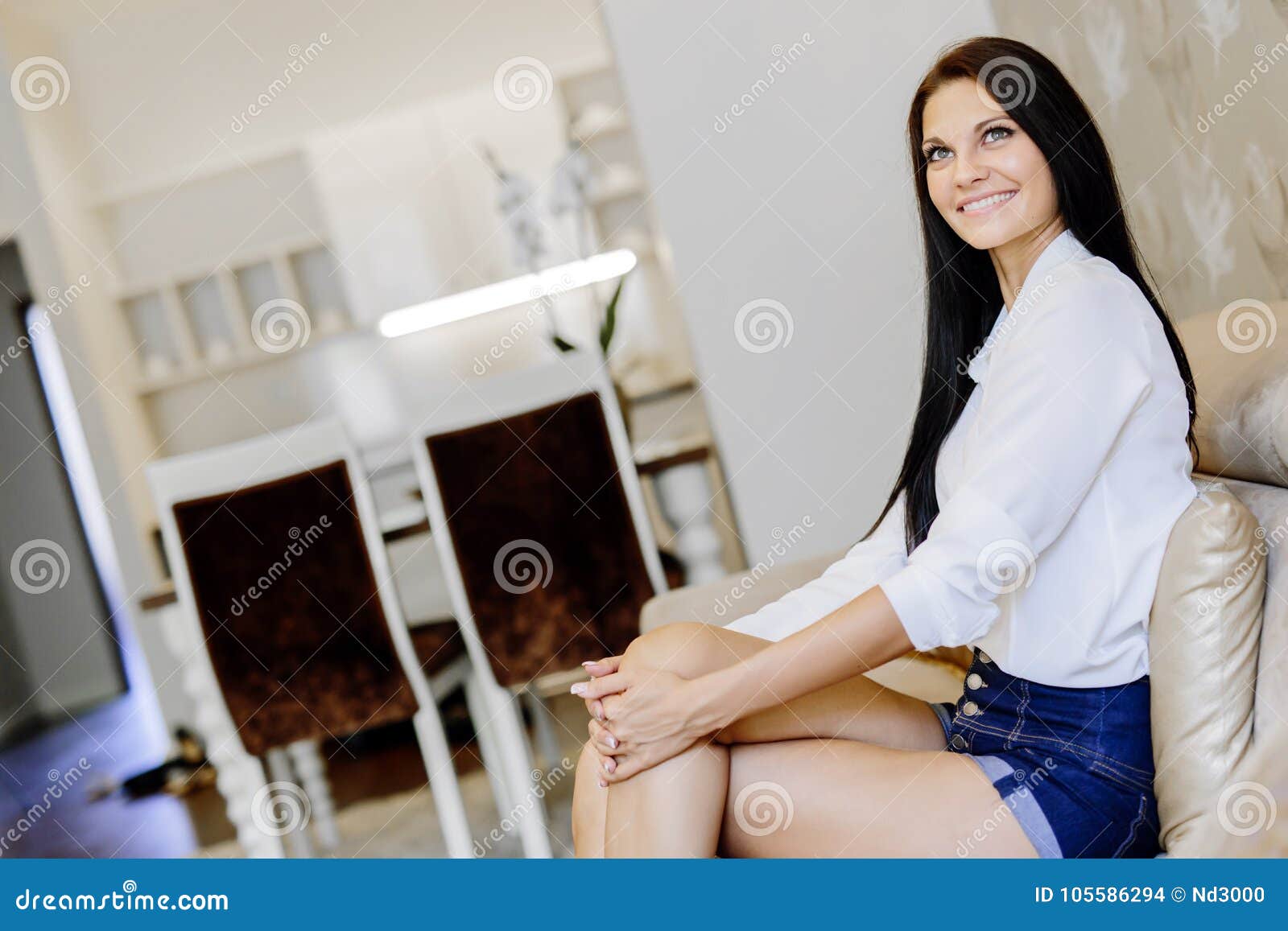 Elegant and Woman Sitting on a Sofa in a Luxurious Room Stock Photo ...