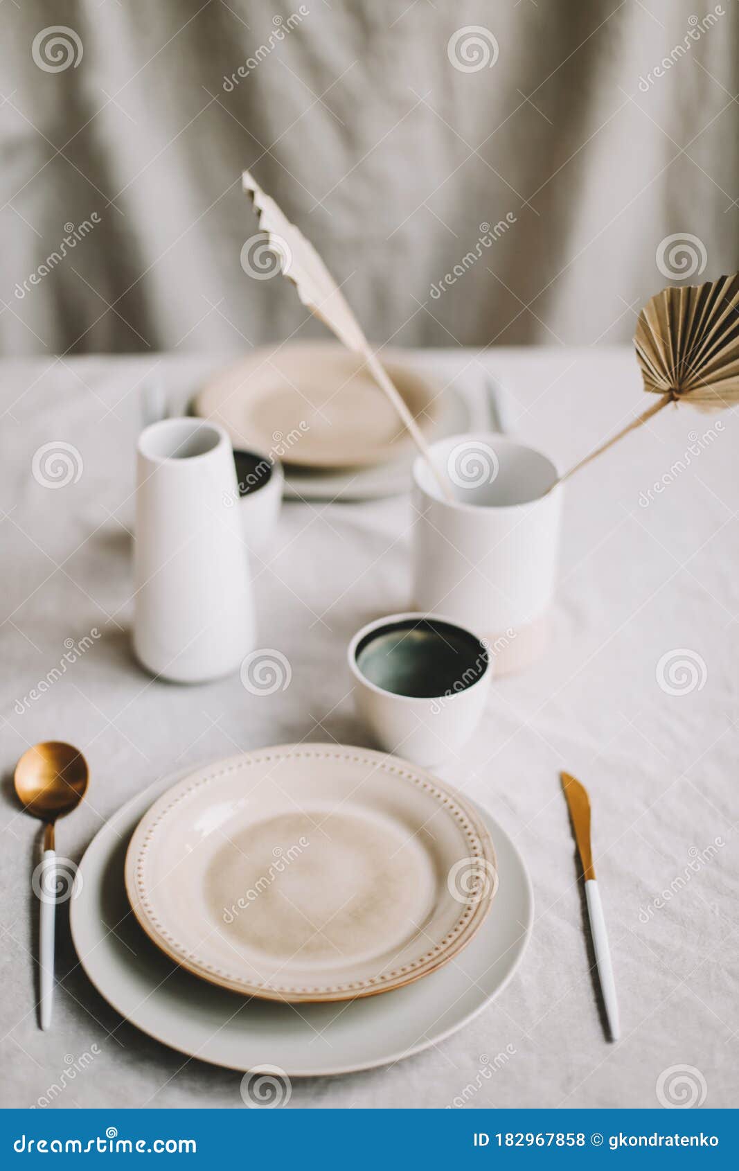 Elegant Table Setting for Fine Dining with Cutlery, Plates, Cups on a