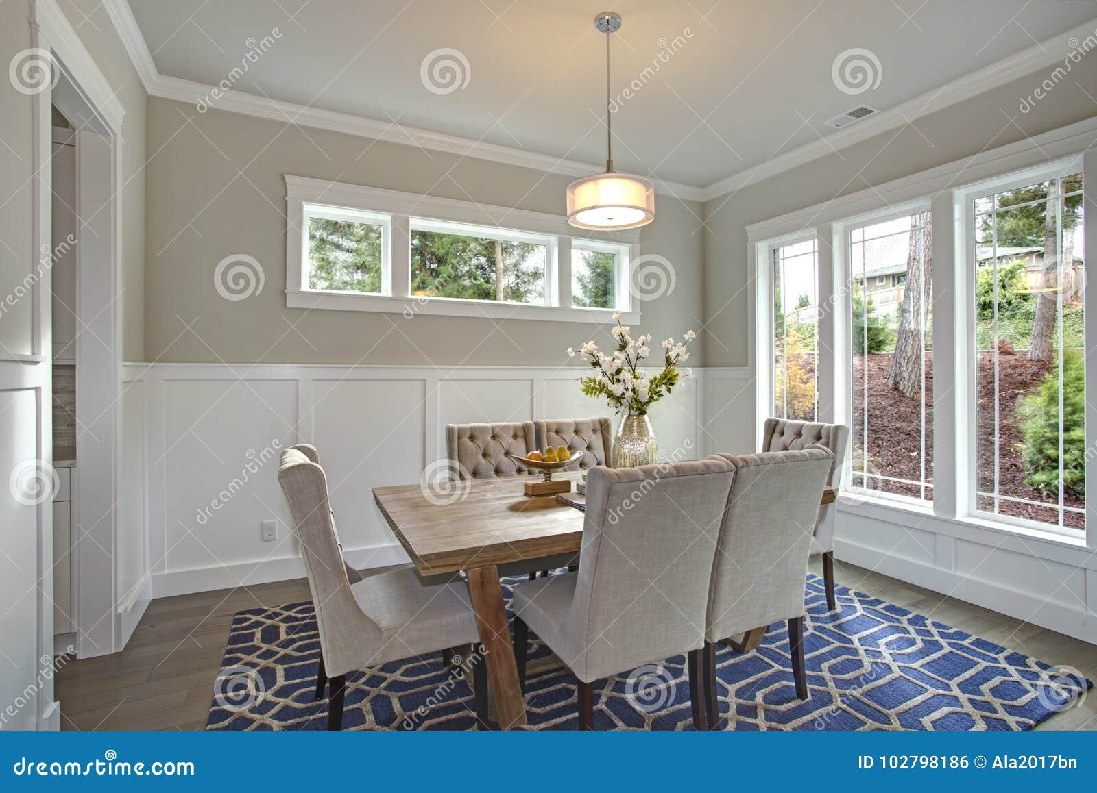 Elegant Transitional Dining Room With Board And Batten Walls