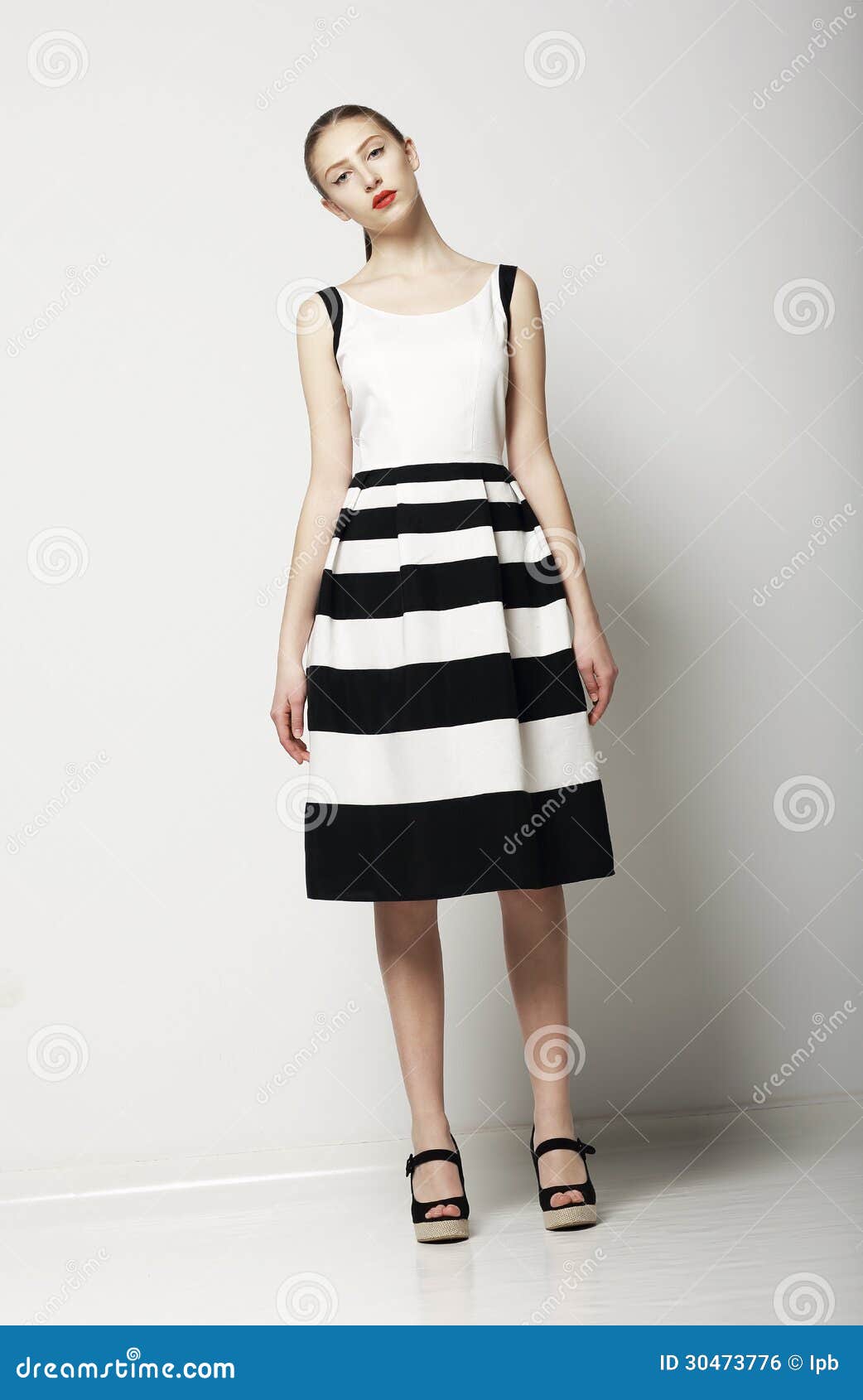 elegant woman fashion model in light striped cotton sundress. vogue style