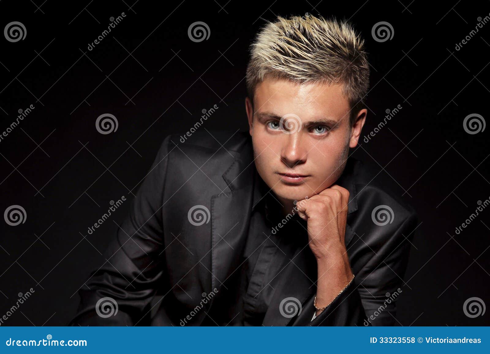 Elegant Young Handsome Man Over Dark. Studio Fashion Portrait Stock