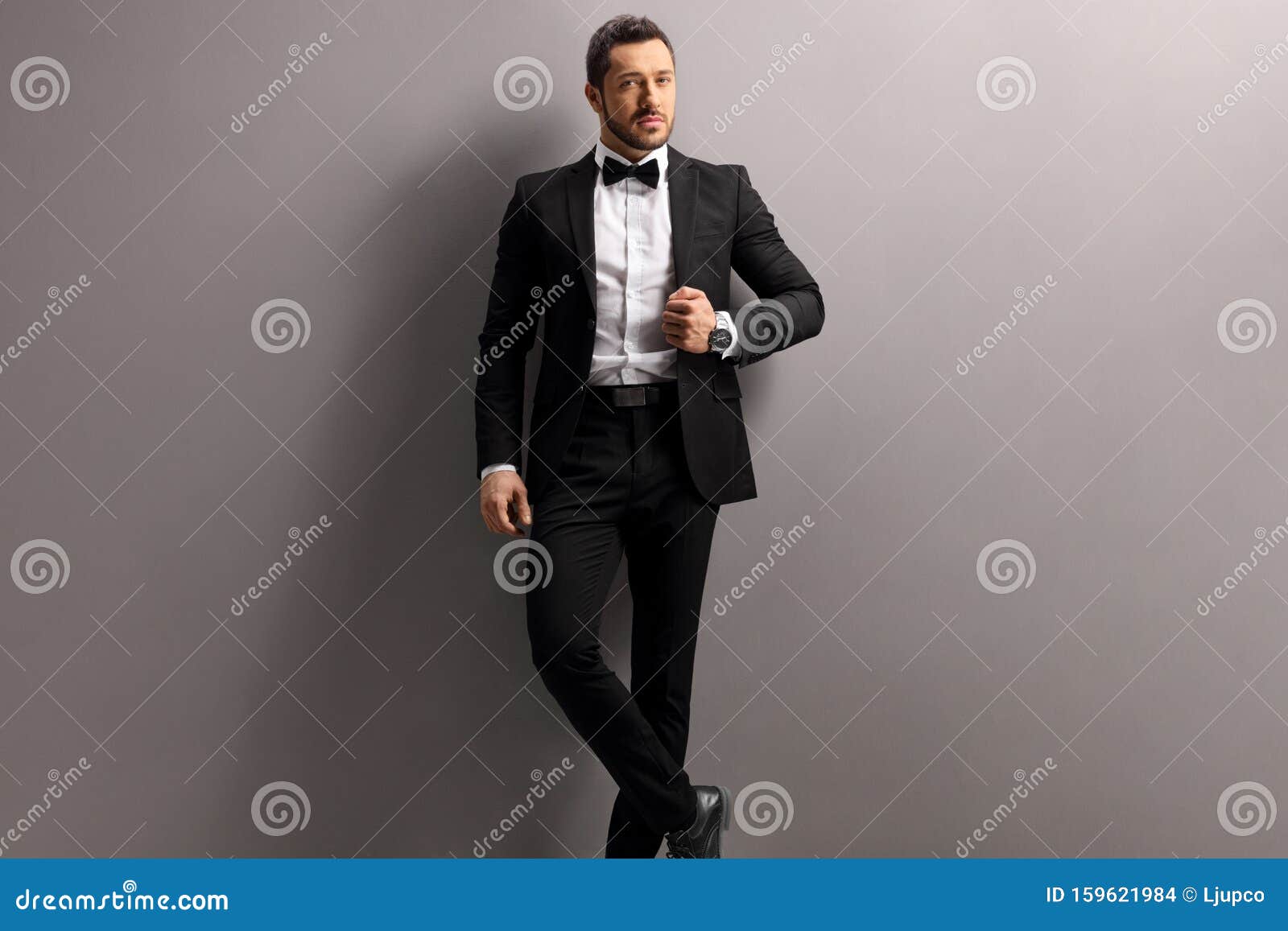 Elegant Young Man in a Black Suit and Bow Tie Stock Photo - Image of ...