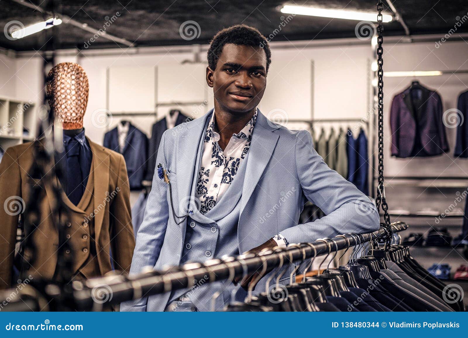 Elegantly Dressed African-American Man Leaning on a Mannequin in a ...
