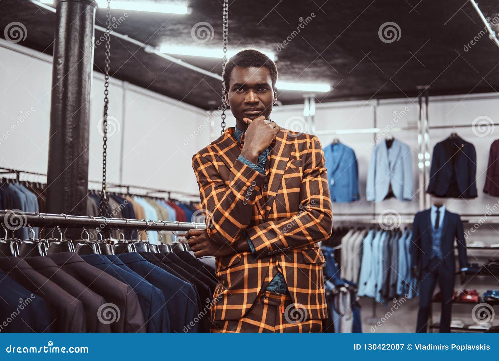 Elegantly Dressed African Man Posing with Hand on Chin while Standing ...