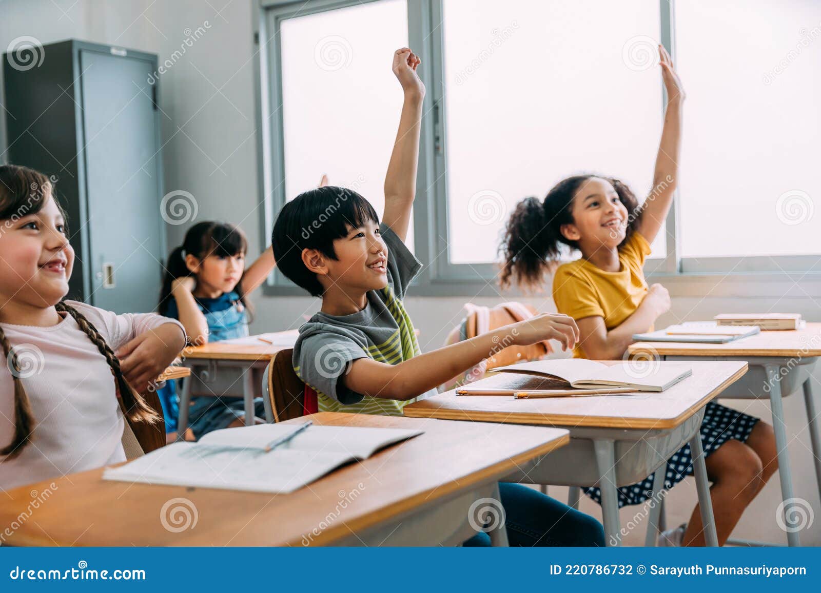 Elementary Age Asian Student Boy Raised Hands Up In Class Diverse