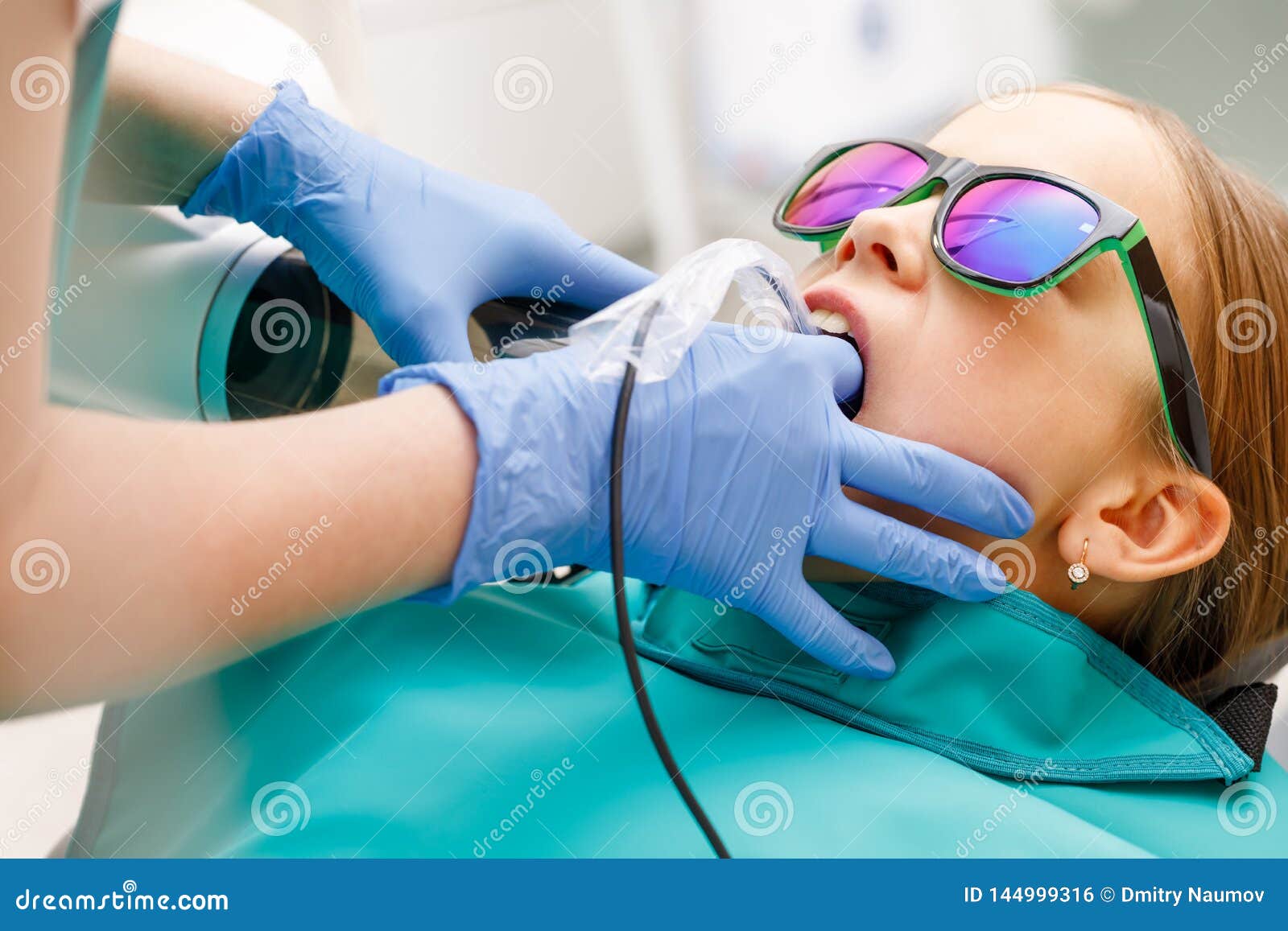 elementary-age-girl-receiving-dental-radiography-or-x-ray-in-pediatric-dental-clinic-stock-photo