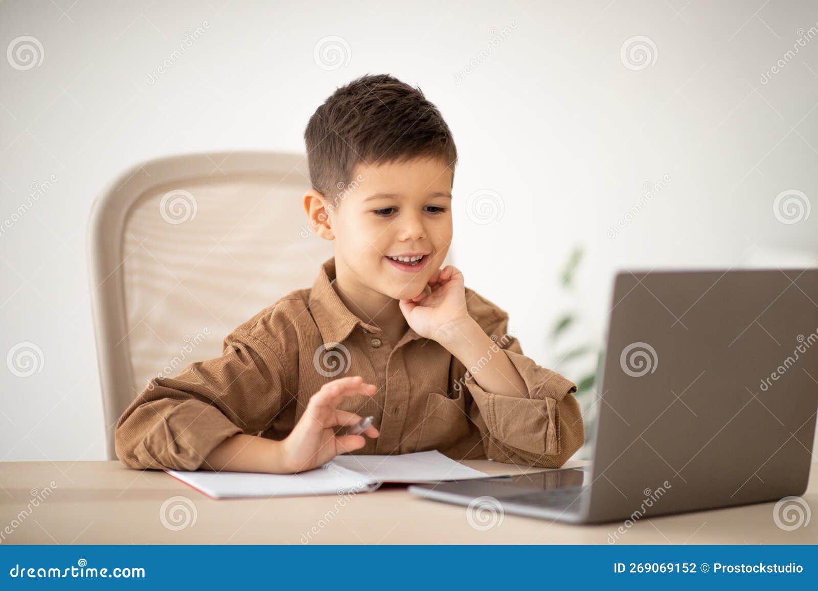 Elementary Education Remotely. Smiling Caucasian Little Child Sit at