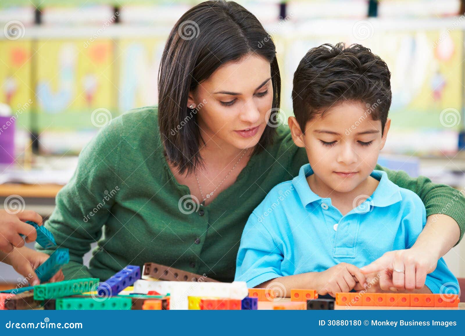 ary pupil counting with teacher in classroom