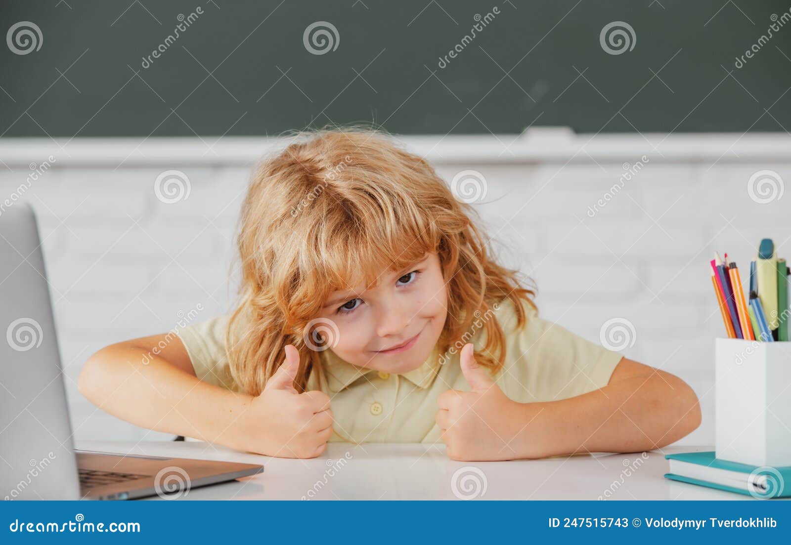Elementary School Kid with Thumbs Up Working in Computer Class. Stock