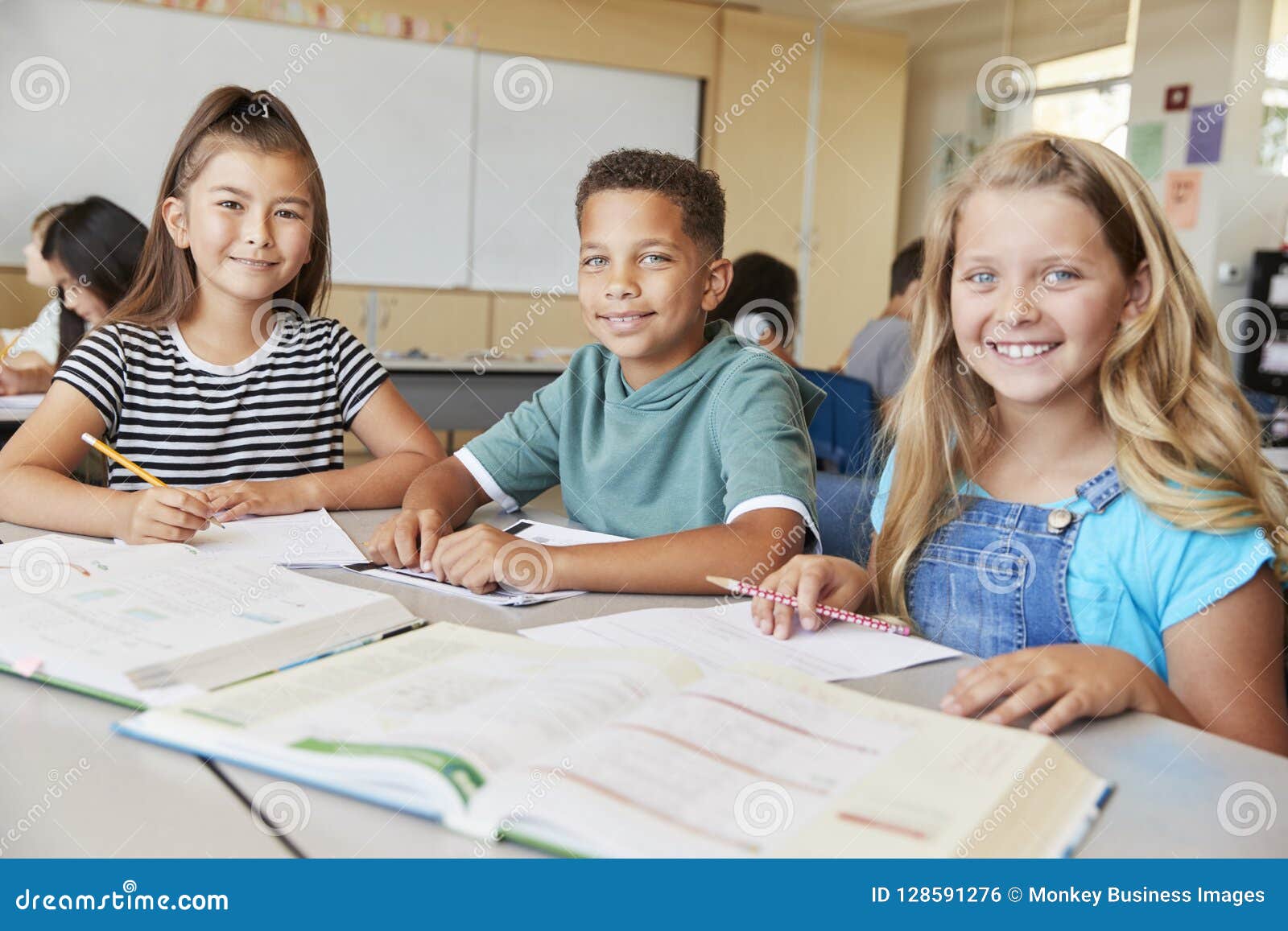 Elementary School Kids In Class Smiling To Camera Close Up Stock Photo elementary-school-kids-in-class-smiling-to-camera-close-up-stock-photo
