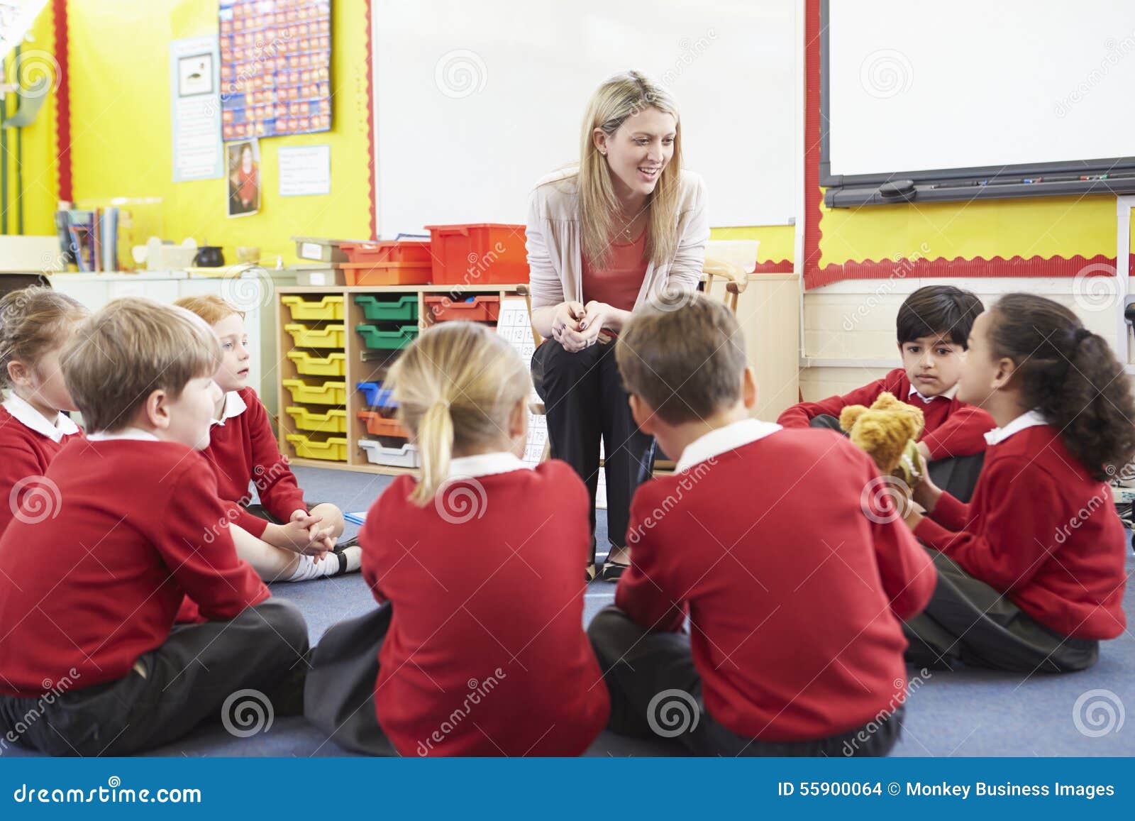 ary school pupils telling story to teacher
