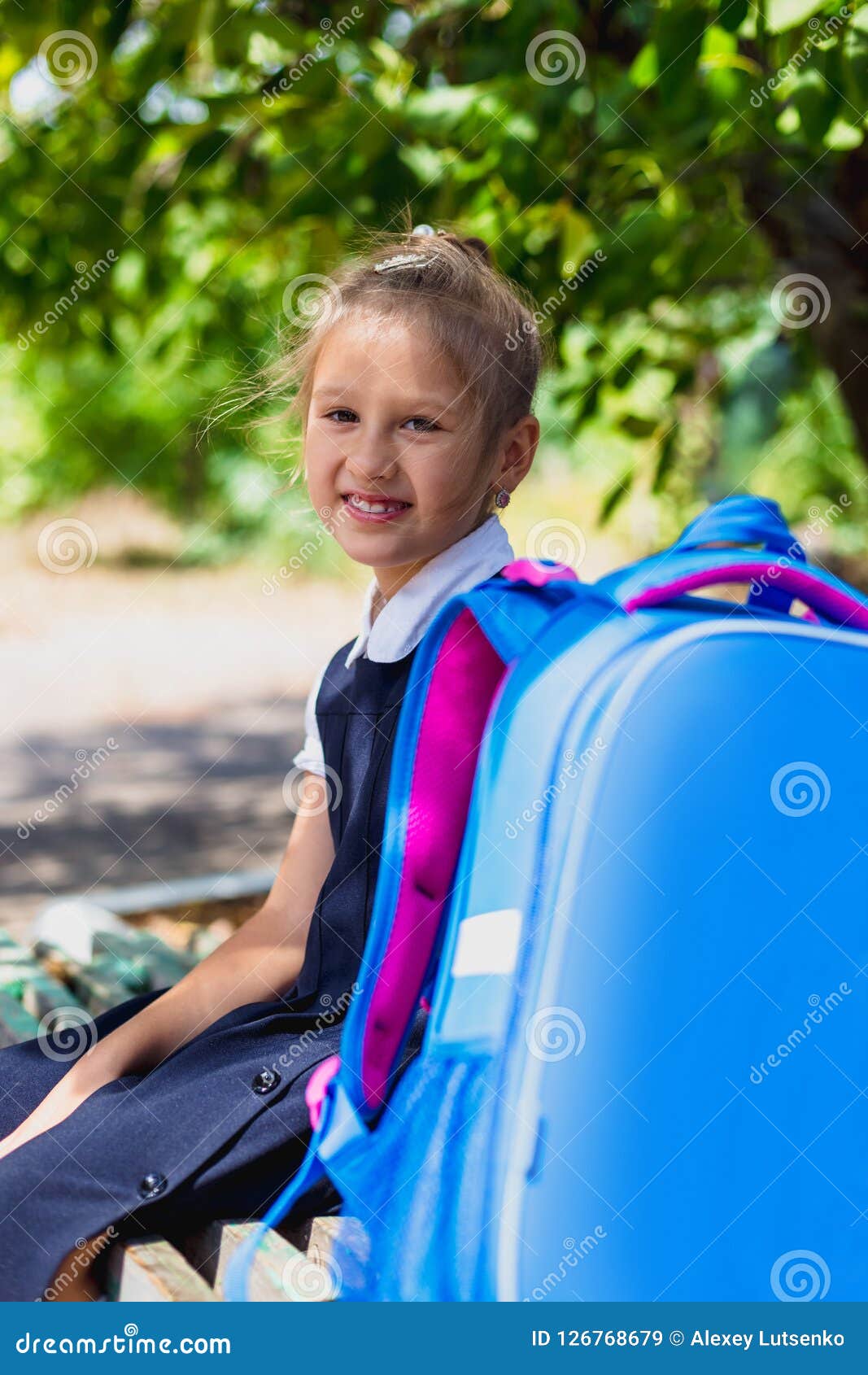 An Elementary School Student Sitting on a Bench. Stock Image Image of