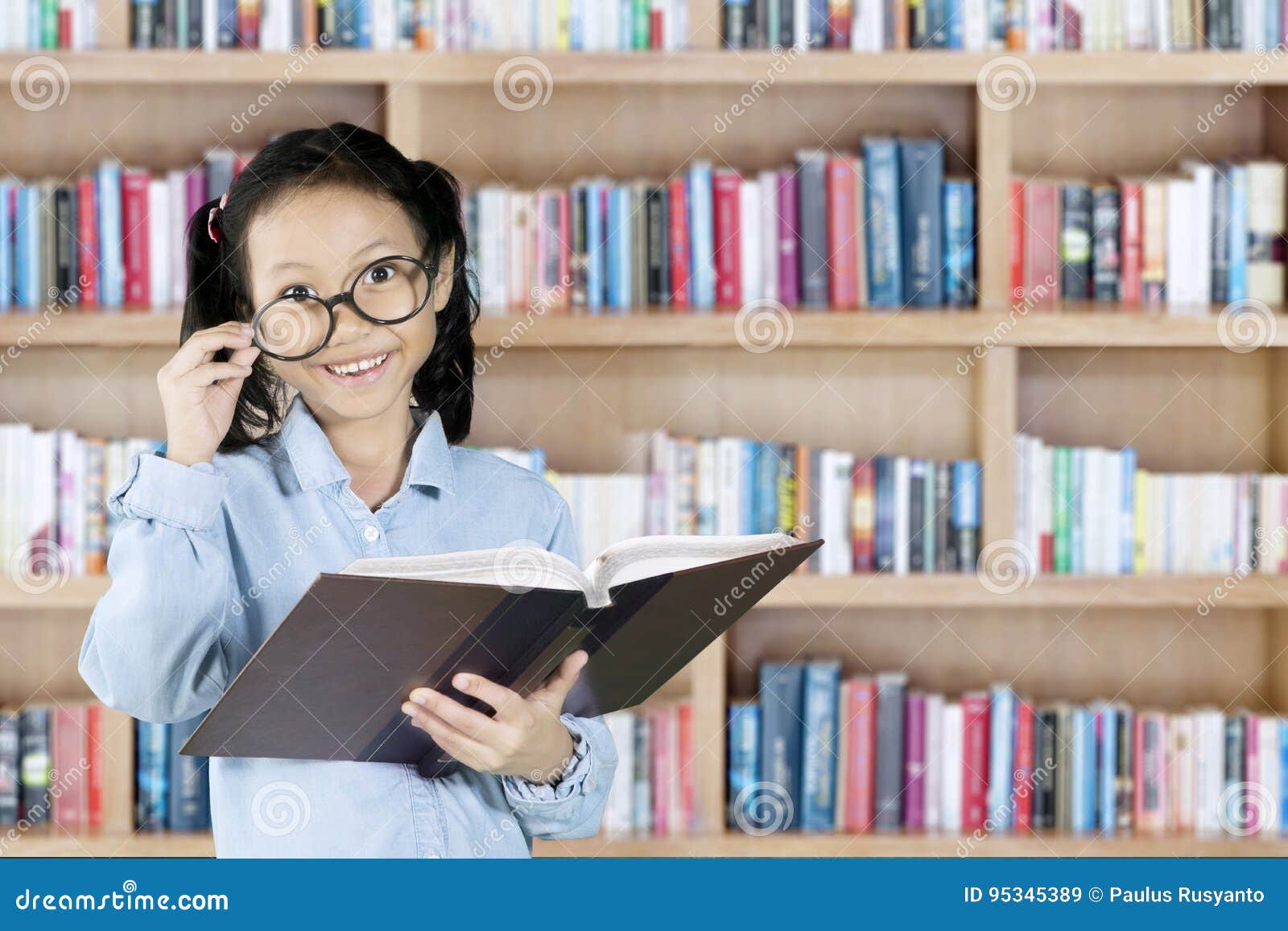 Elementary Student Holding Book in Library Stock Image Image of female, book 95345389