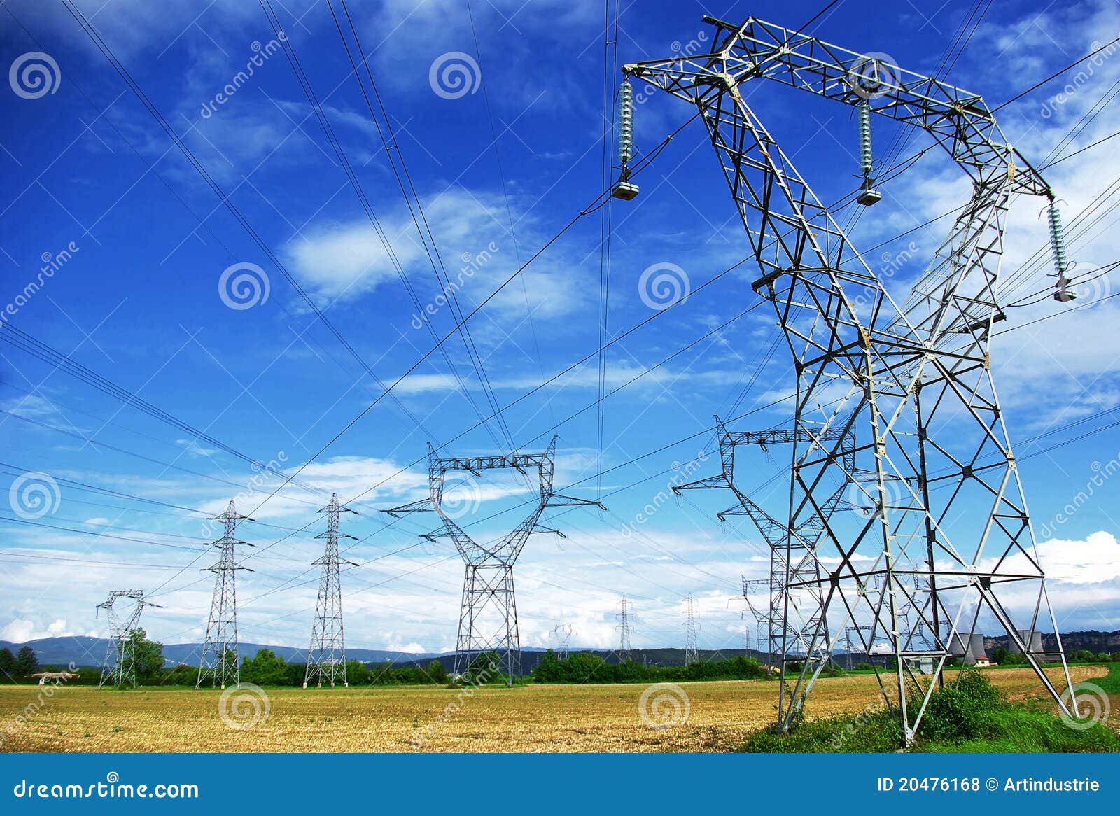 Eletric pylones in fields stock photo. Image of blue 20476168