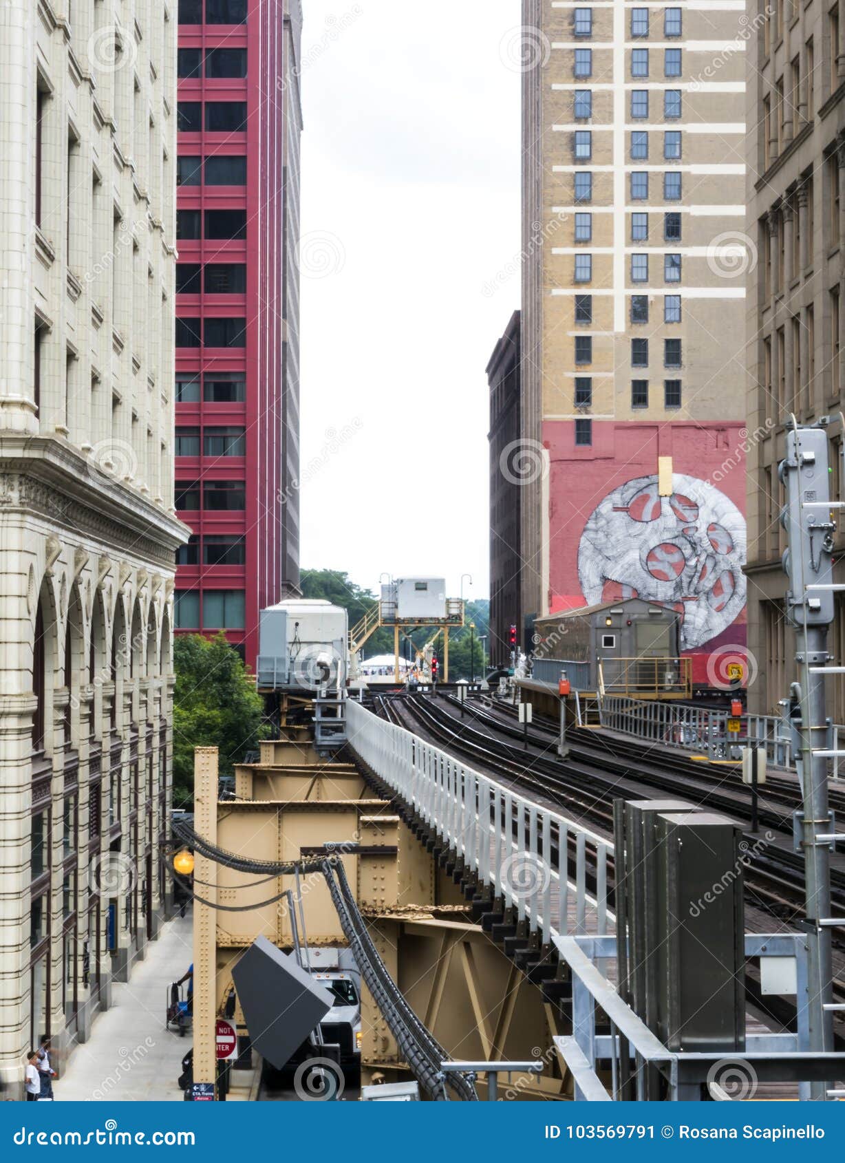 Elevated Train Tracks Above the Streets and between Buildings at the