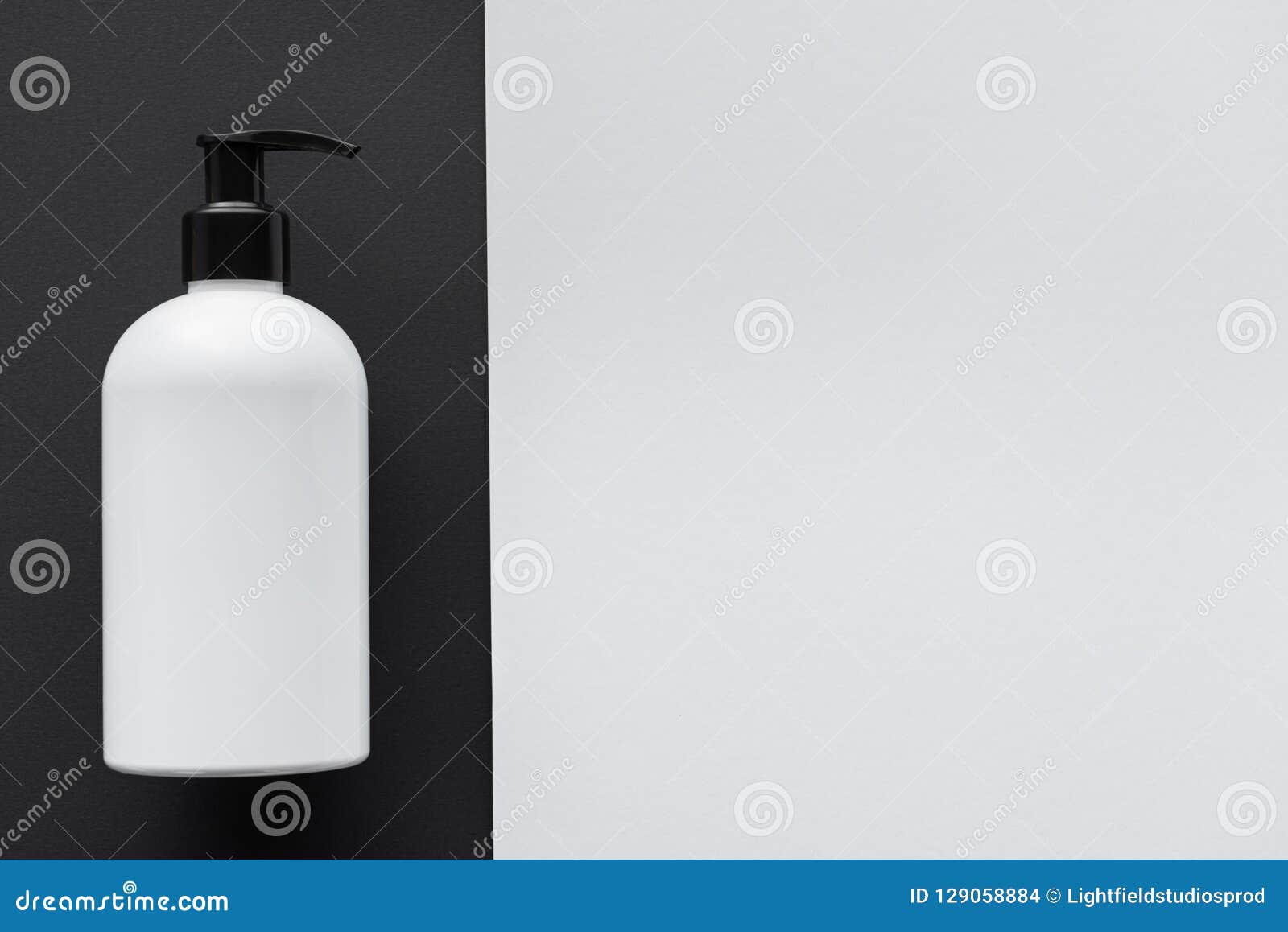 Elevated View of Bottle of Cream on Black and White Surface Stock Photo
