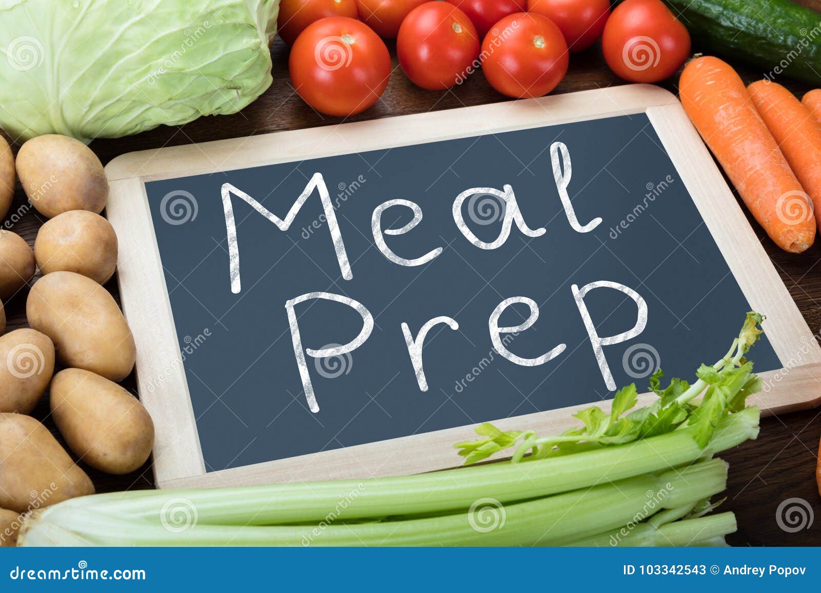 meal preparation words on slate with vegetables