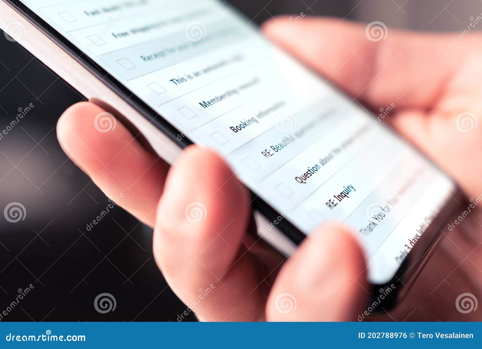 email inbox in mobile phone with list of new unread messages, marketing newsletters and spam. person looking at digital mail.