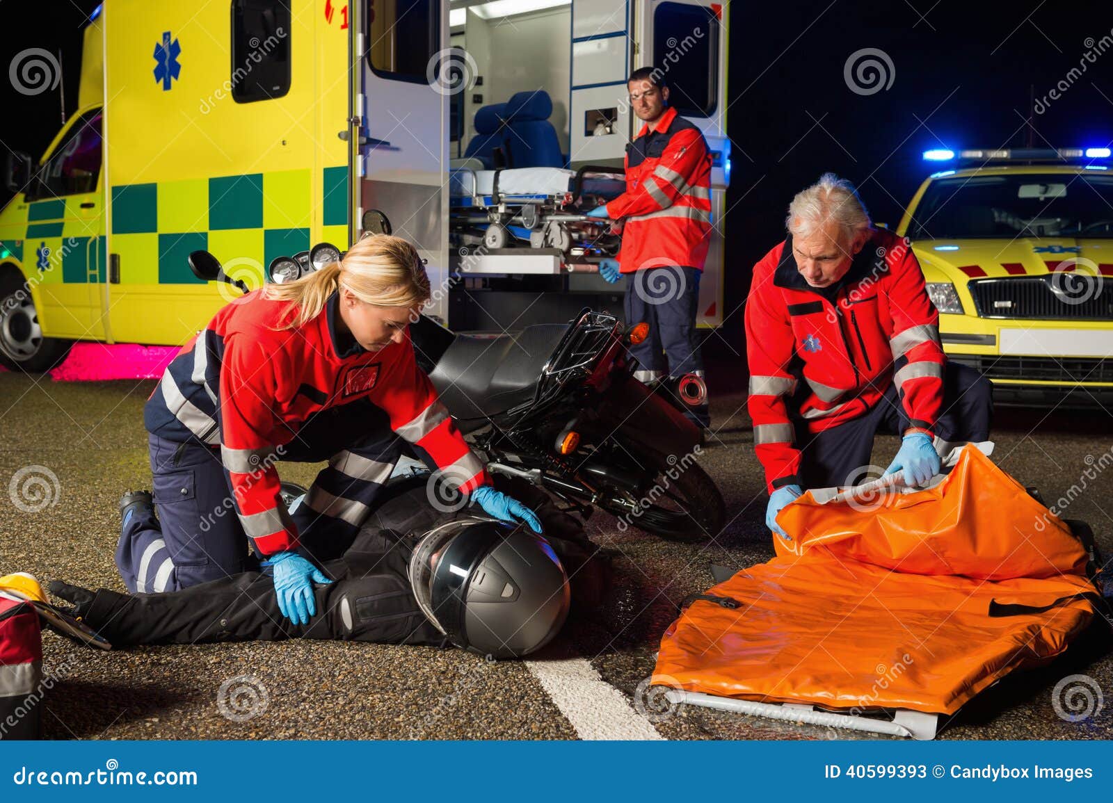 emergency team assisting injured motorbike driver