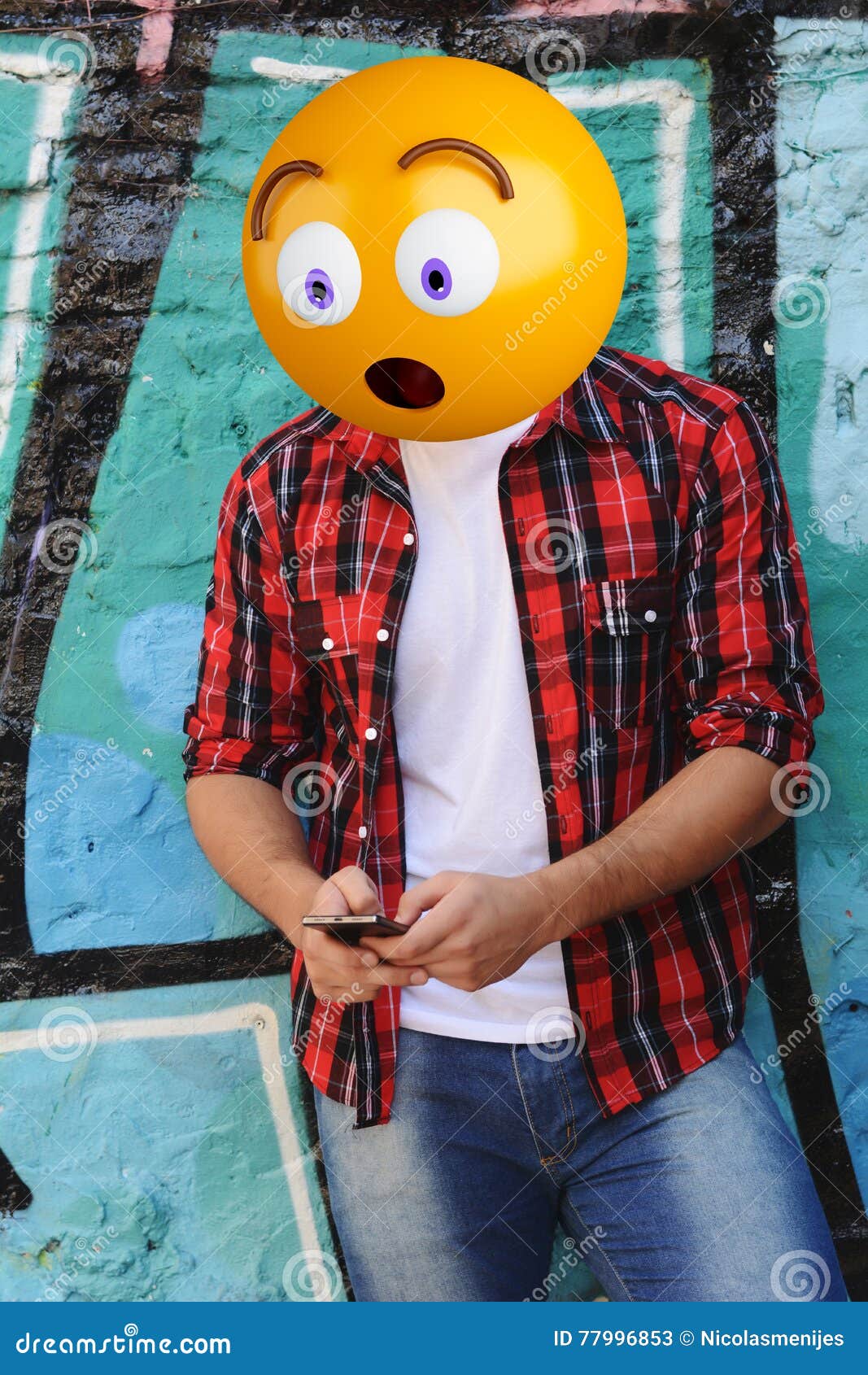 Surprise emoji head man using a smartphone. Emoji concept