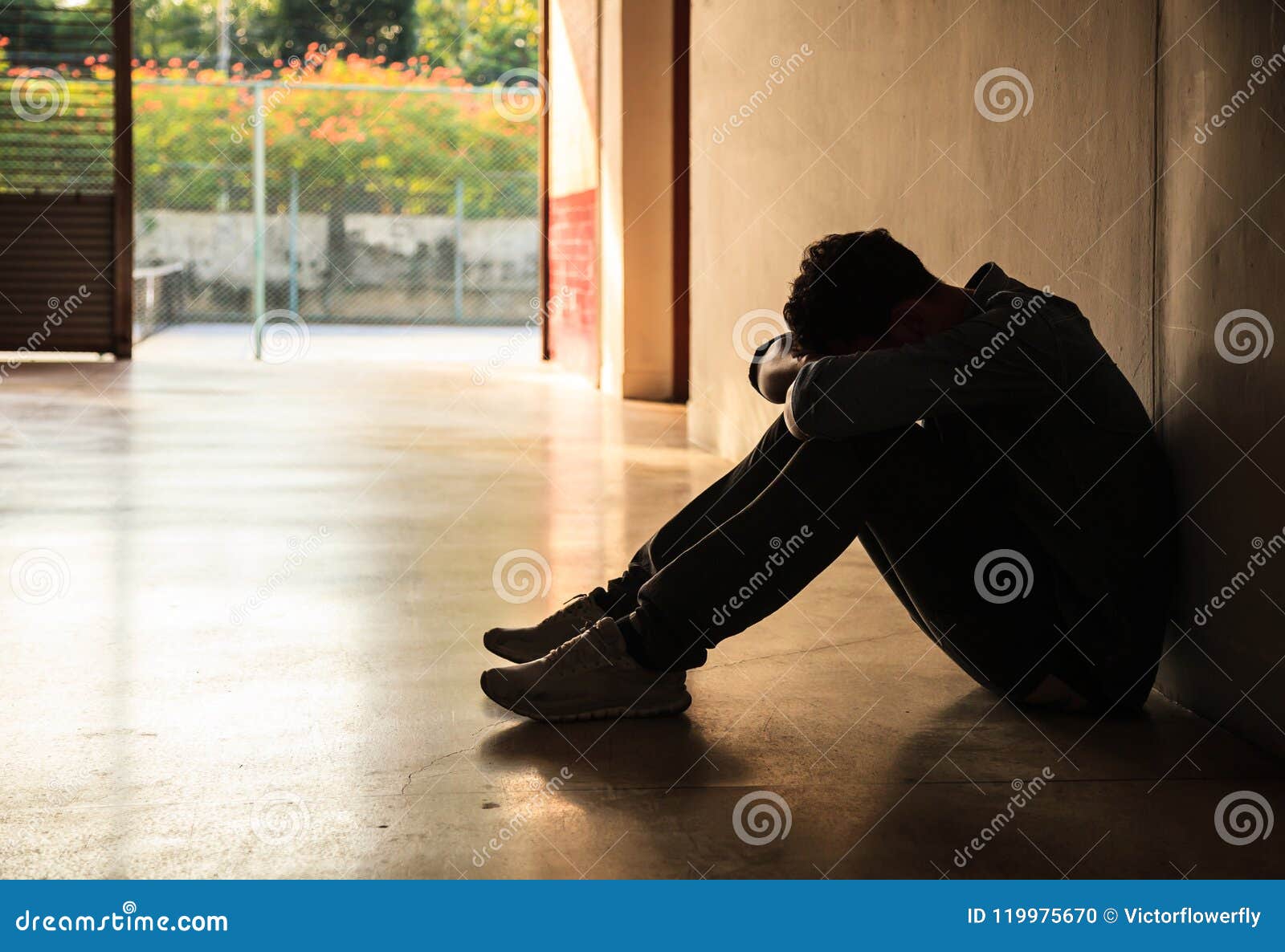 Emotional Moment: Man Sitting Holding Head Low on Knees, Stressed ...