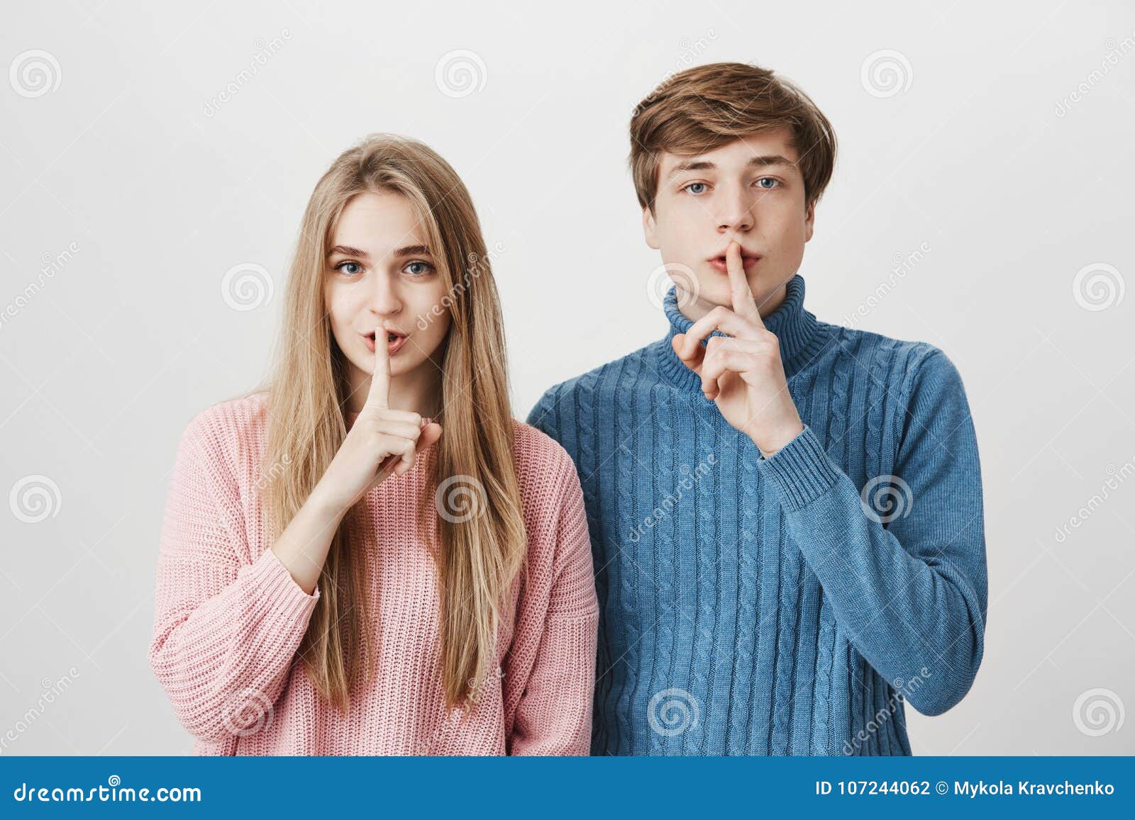 Emotional Young European Man and Woman with Blonde Hair Dressed in Pink and Blue Sweaters Holding Fingers at Lips Stock Photo - Image of indoors, boyfriend: 107244062 Emotional Young European Man and Woman with Blonde Hair Dressed in Pink and Blue Sweaters Holding Fingers at Lips Stock Photo - Image of indoors, boyfriend: 107244062